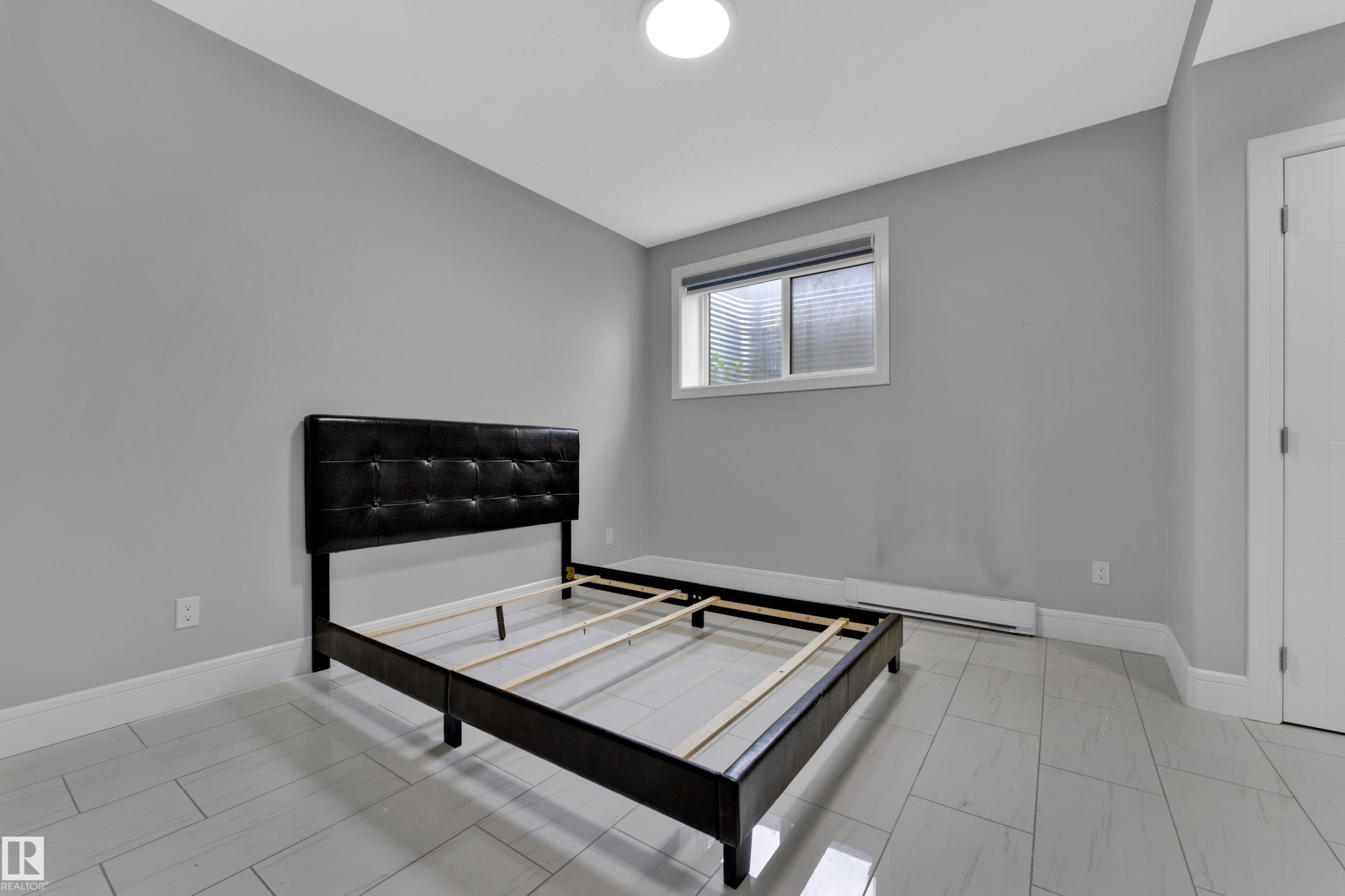 Room with light gray walls, white baseboards, and light-toned tile flooring - 9329 Connors Road, Edmonton, AB - Indoor