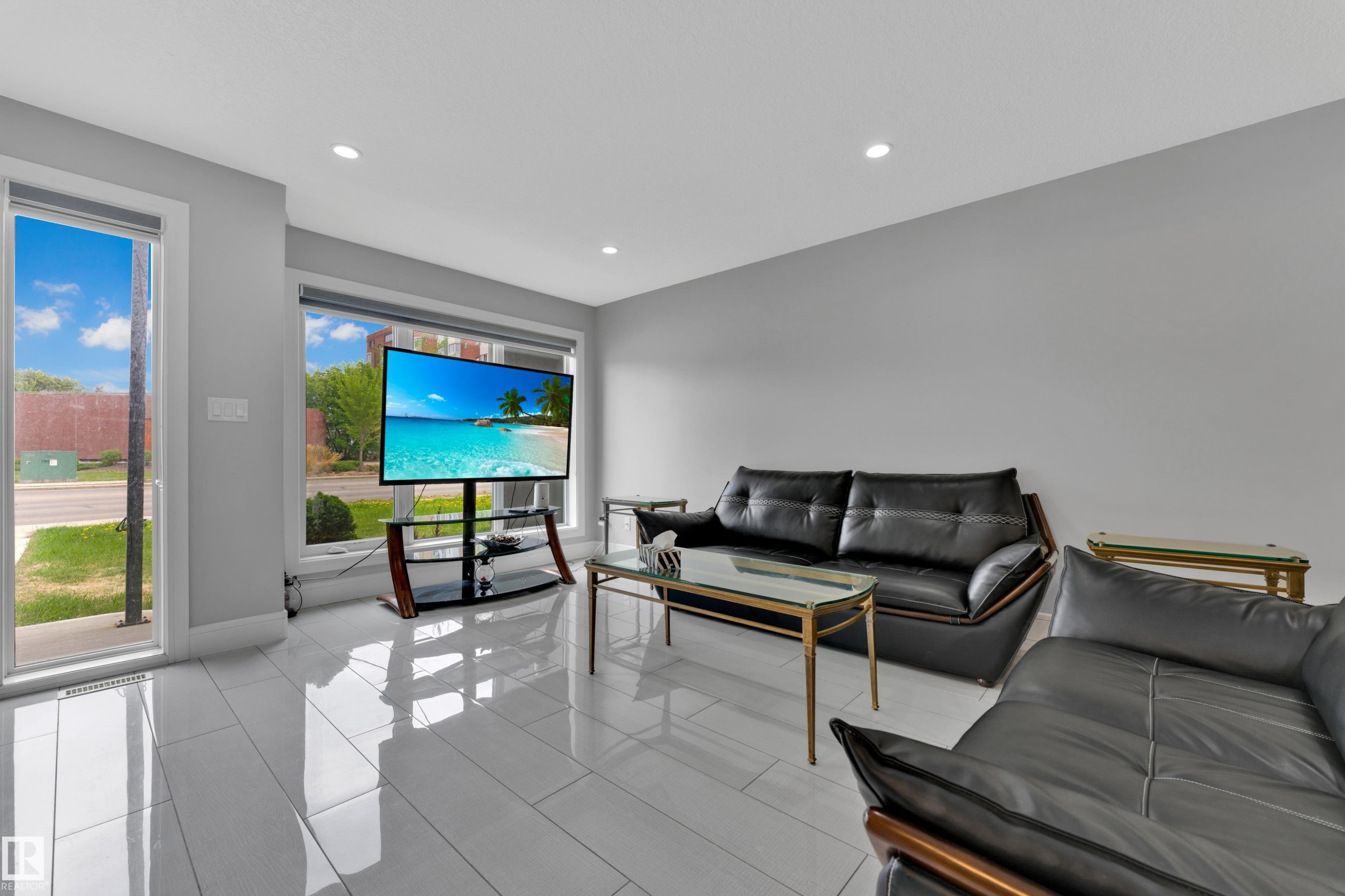 Bright living space featuring large windows, recessed lighting, and expansive white tile flooring - 9329 Connors Road, Edmonton, AB - Indoor Photo Showing Living Room