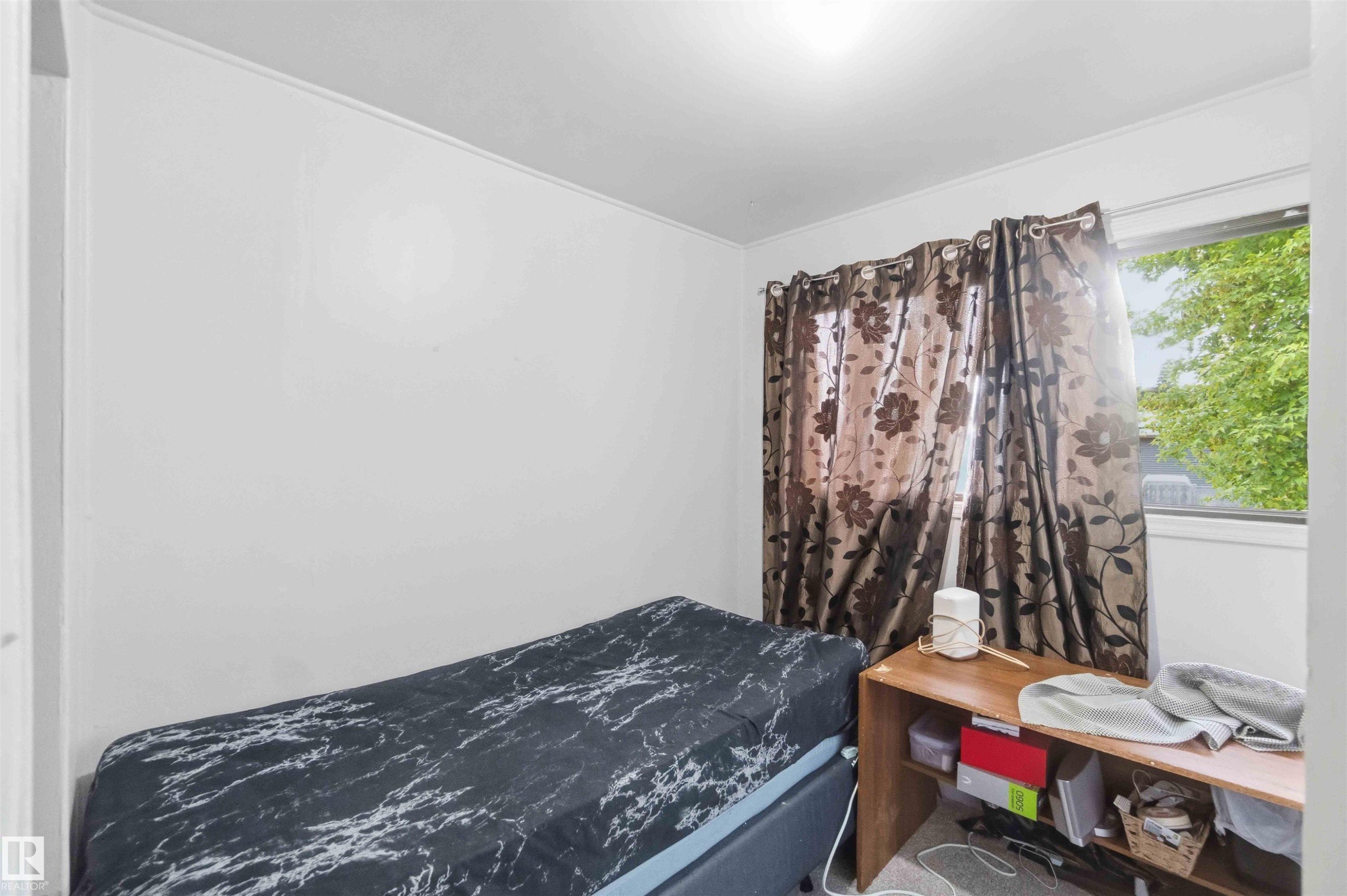 Room featuring a window with natural light, a light-colored ceiling, and white wall finishes - 16 Michigan Street, Devon, AB - Indoor Photo Showing Bedroom