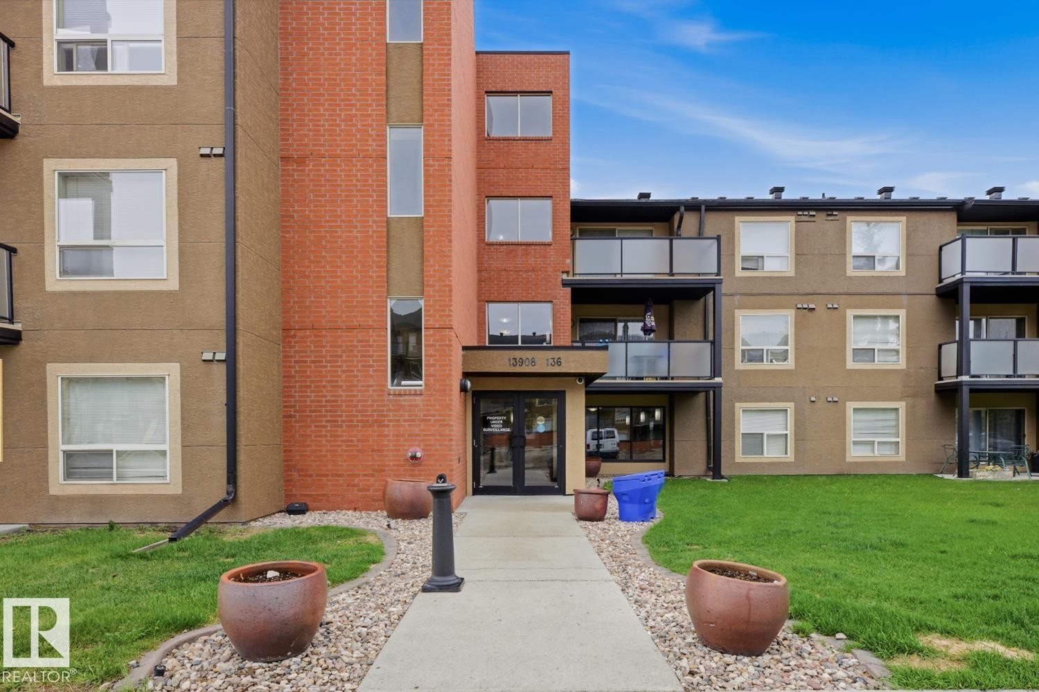 Multi-story building featuring a brick and stucco exterior - #312 13908 136 St Nw, Edmonton, AB - Outdoor With Balcony