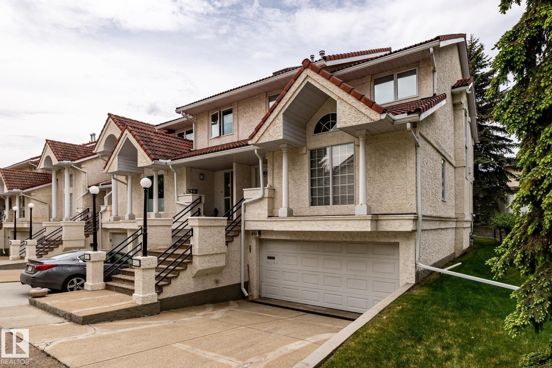 Stucco exterior with a terracotta-style tile roof - 4632 151 Street, Edmonton, AB - Outdoor With Facade