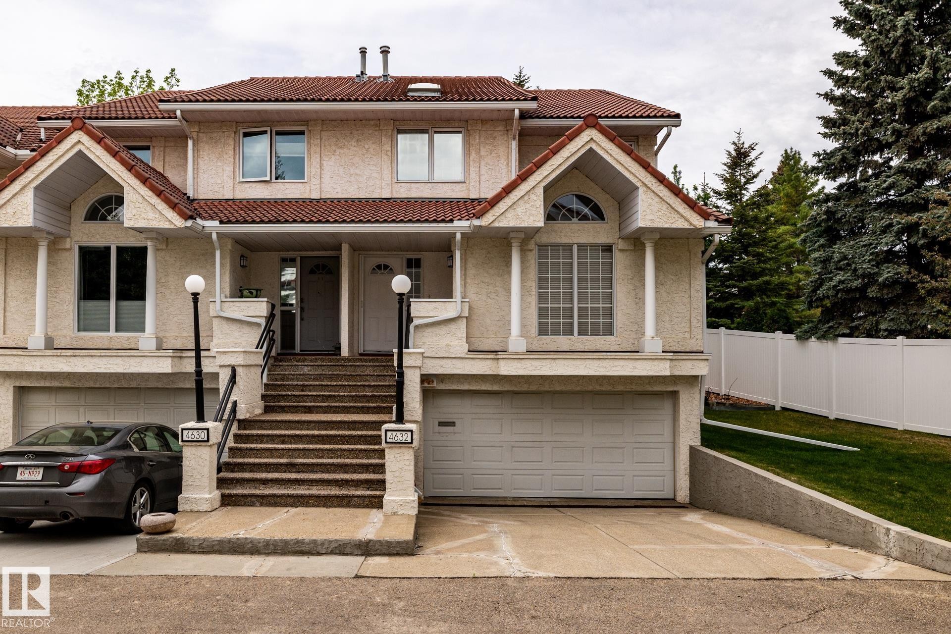 Two-story stucco townhouse with a red tile roof - 4632 151 Street, Edmonton, AB - Outdoor With Facade