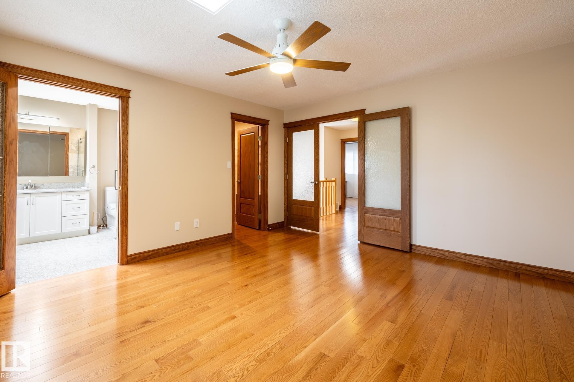 Hardwood flooring throughout the room, complemented by a skylight and a ceiling fan - 4632 151 Street, Edmonton, AB - Indoor Photo Showing Other Room