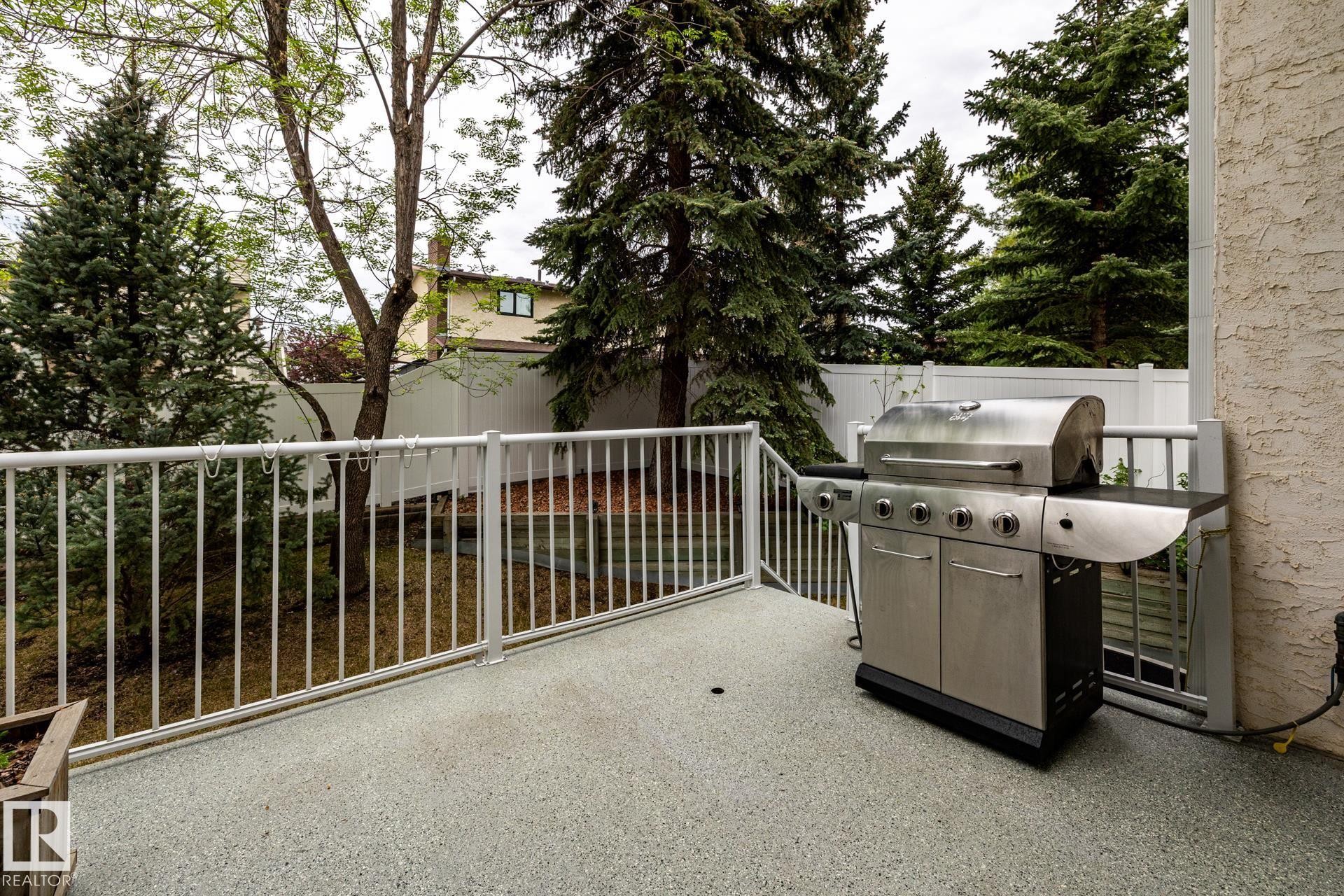 Private outdoor deck with a textured, light-colored surface - 4632 151 Street, Edmonton, AB - Outdoor With Exterior