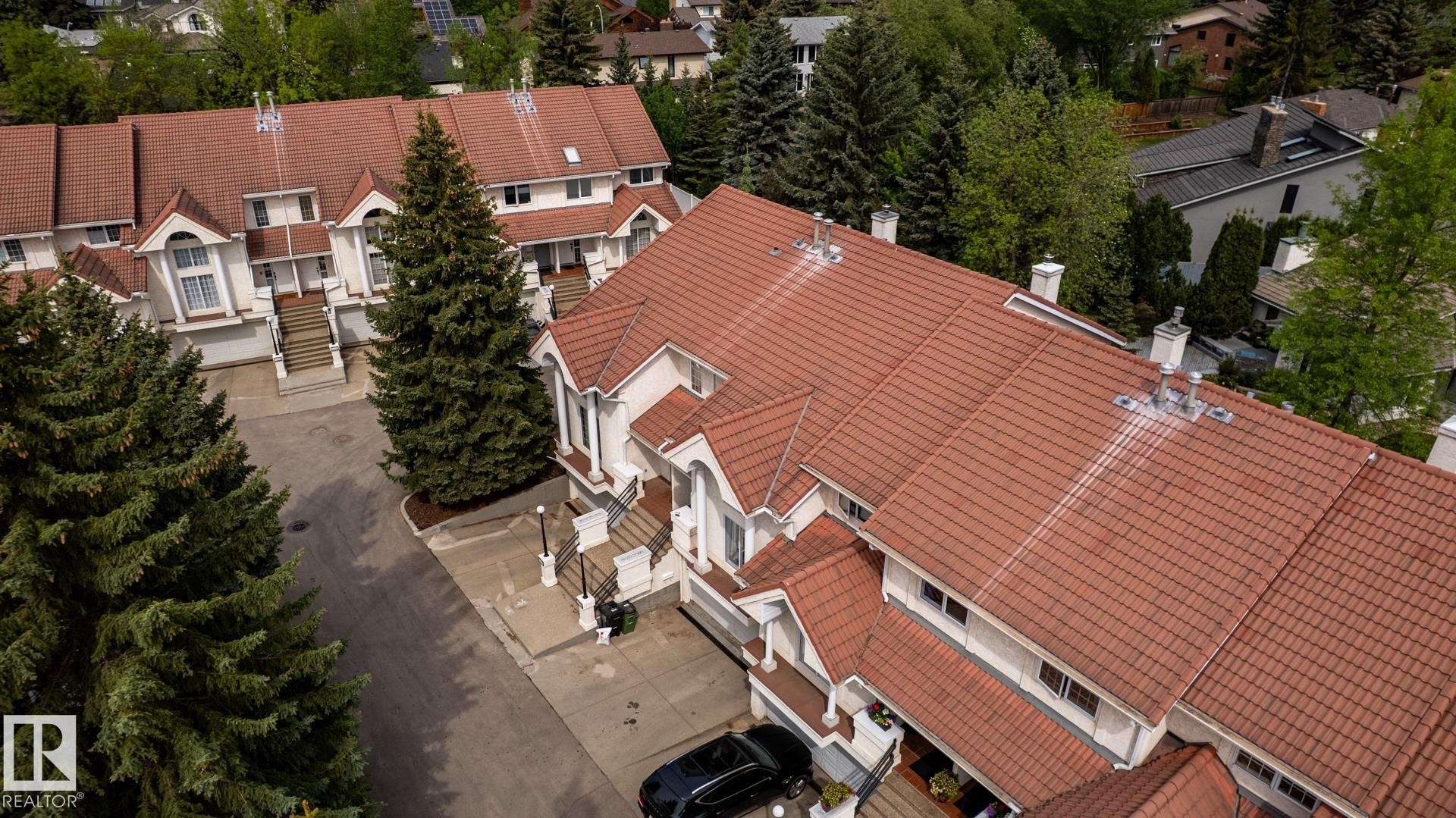 Townhome complex with terracotta tile roofing and white stucco exteriors - 4632 151 Street, Edmonton, AB - Outdoor