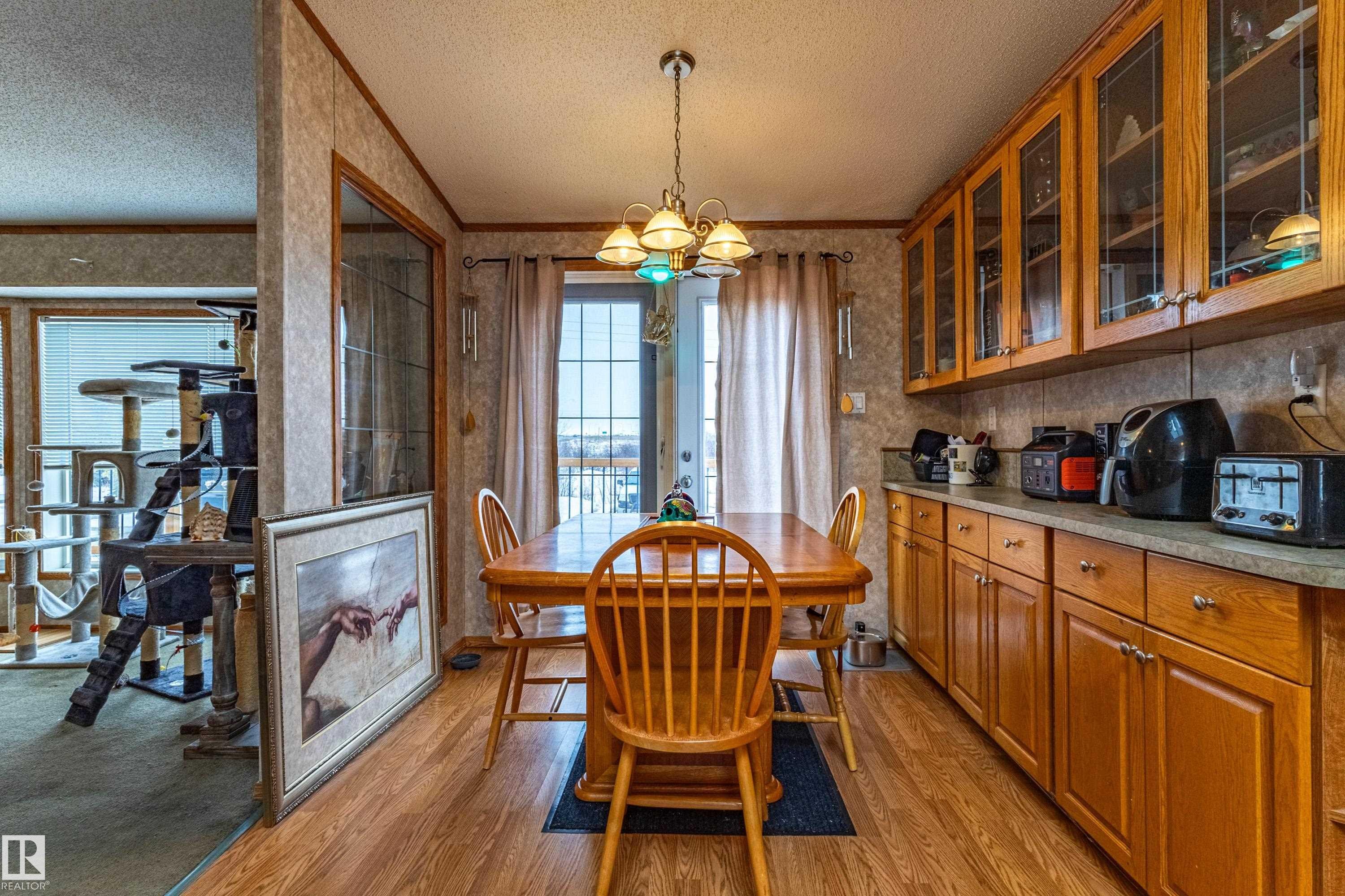 Dining area featuring wood-finish flooring and a brass-tone chandelier - 1529 Range Road 272 Rural Parkland County, Alberta, Rural Parkland County, AB - Indoor