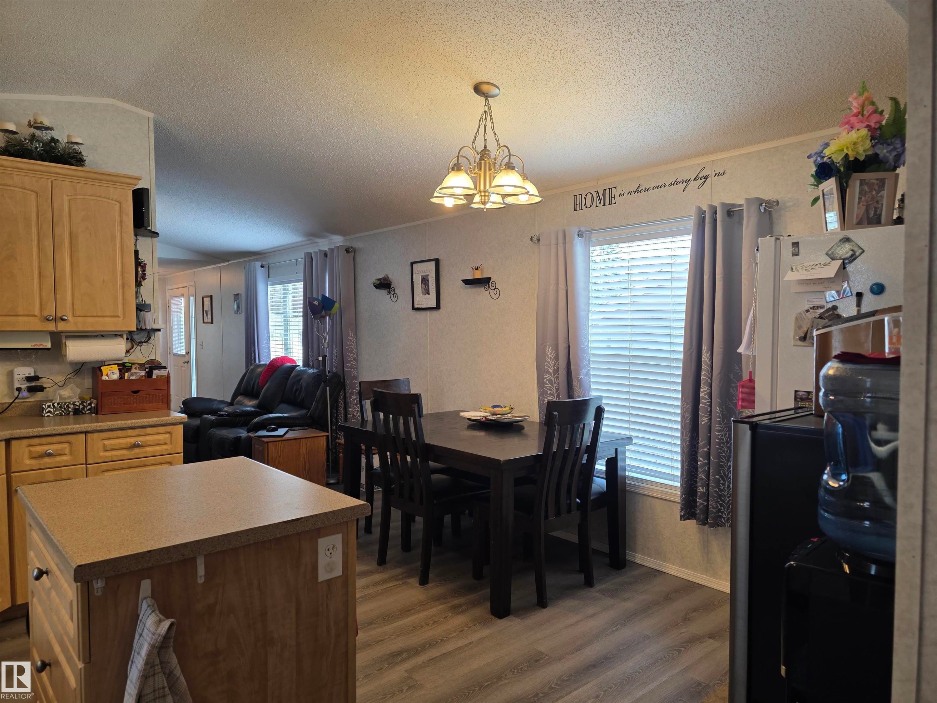 Open concept living area featuring vinyl plank flooring, - 5012 53 Ave, Breton, AB