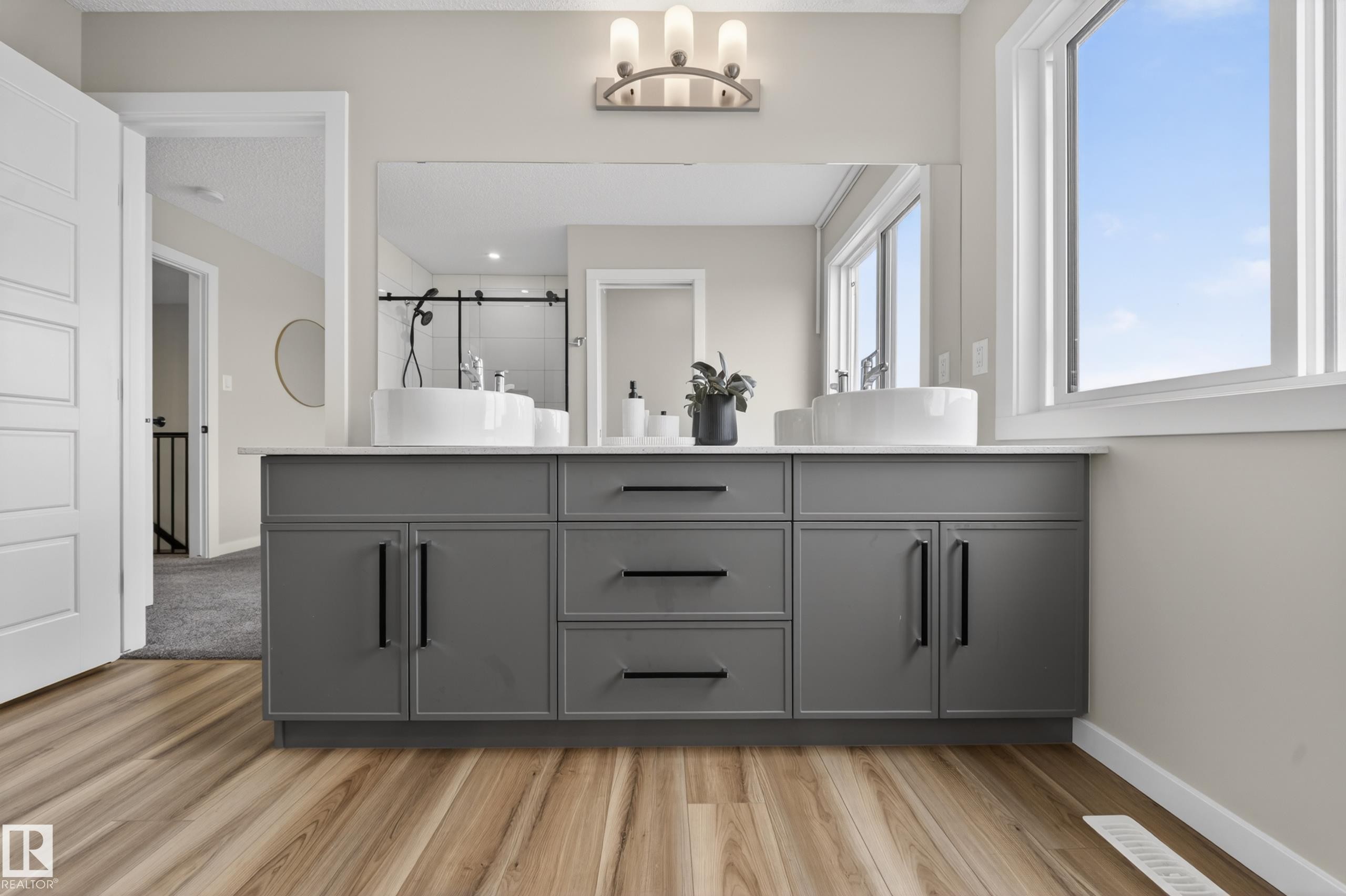Double vanity with a light gray cabinet base, white countertop, and two vessel sinks - 3337 Kulay Way, Edmonton, AB - Indoor