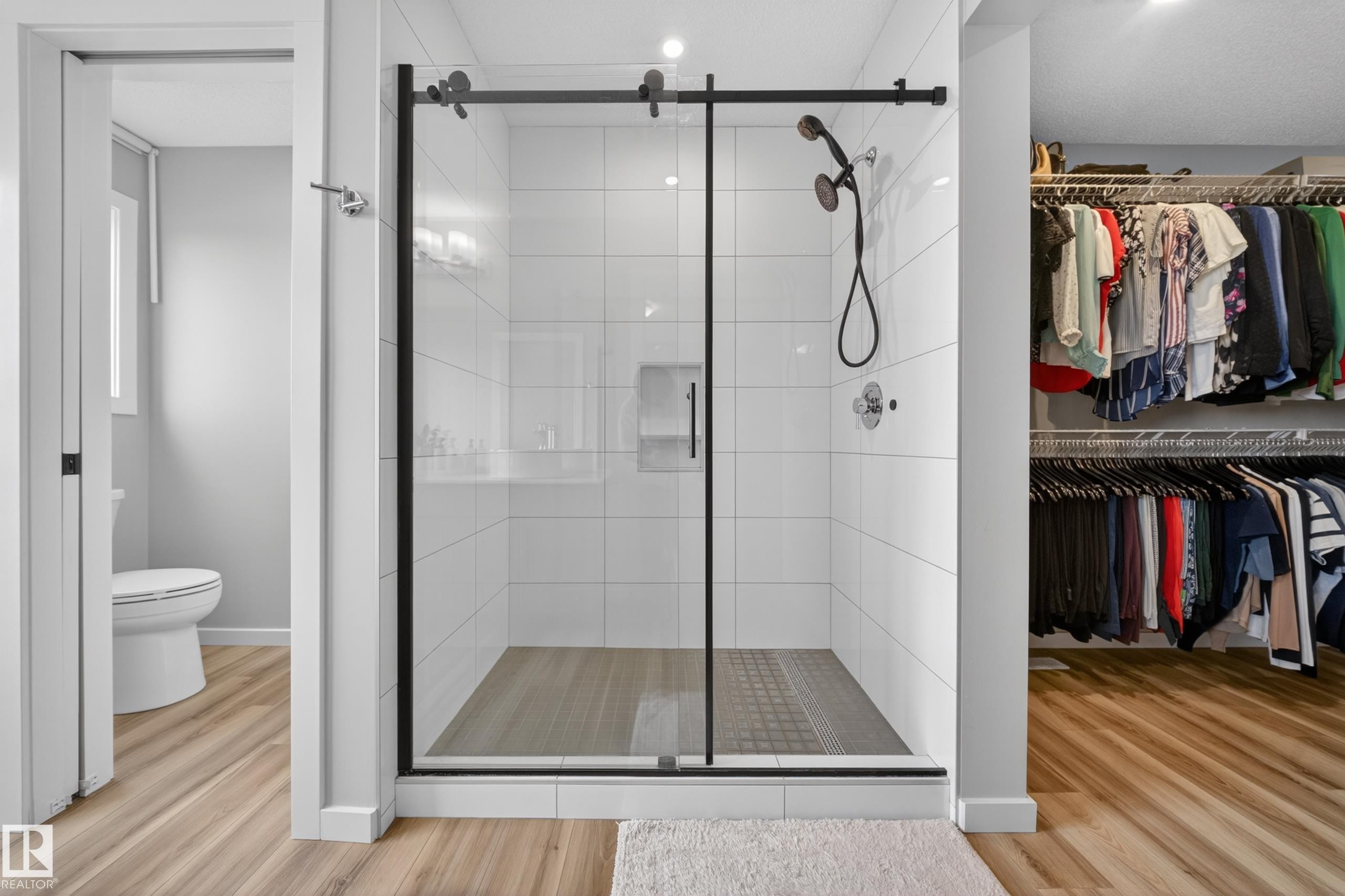 Walk-in shower with clear glass enclosure, matte black hardware, and white subway tile surround - 3337 Kulay Way, Edmonton, AB - Indoor Photo Showing Bathroom