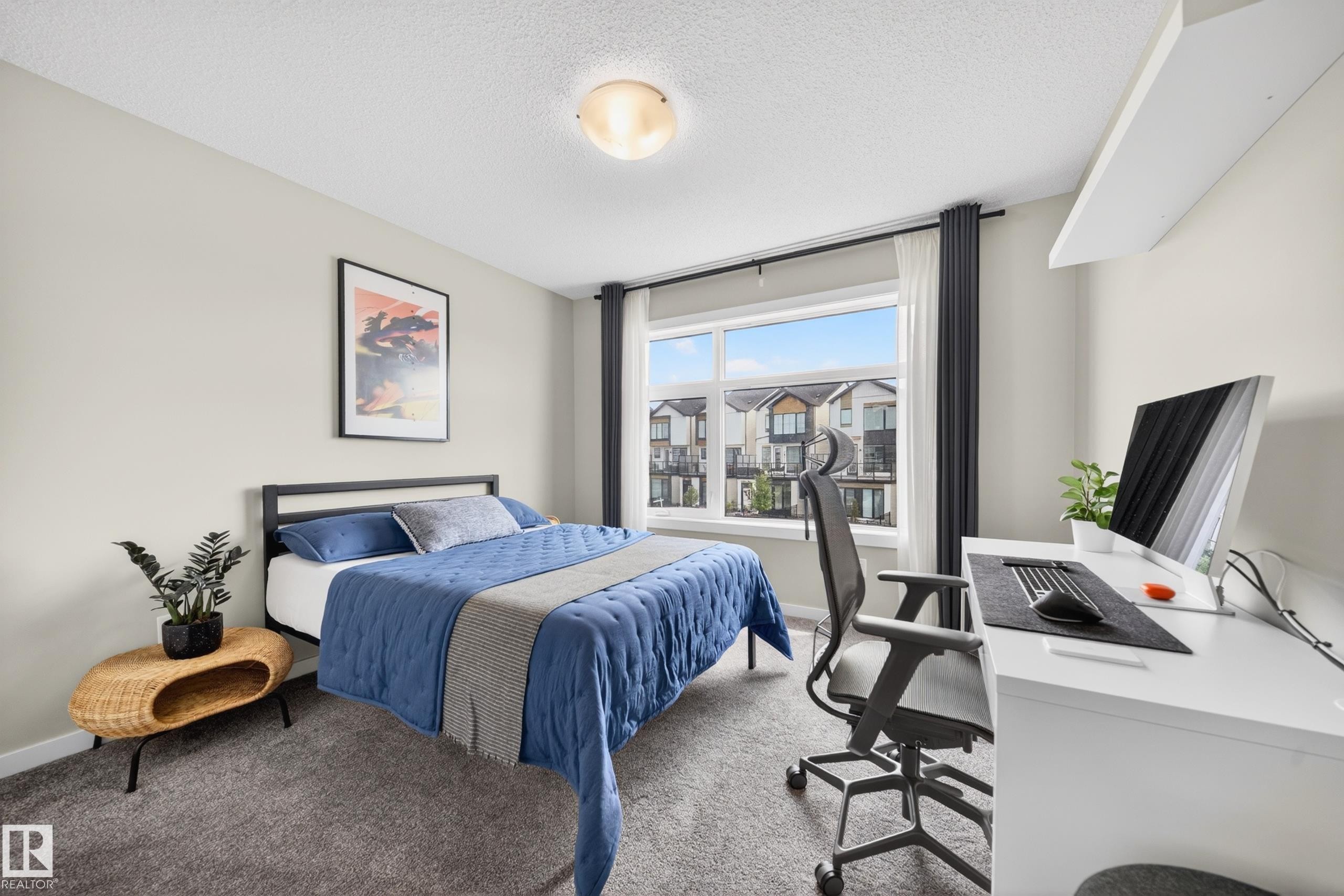 Carpeted room featuring a large window, a built-in wall shelf, and an overhead flush-mount light fixture - 3337 Kulay Way, Edmonton, AB - Indoor Photo Showing Bedroom
