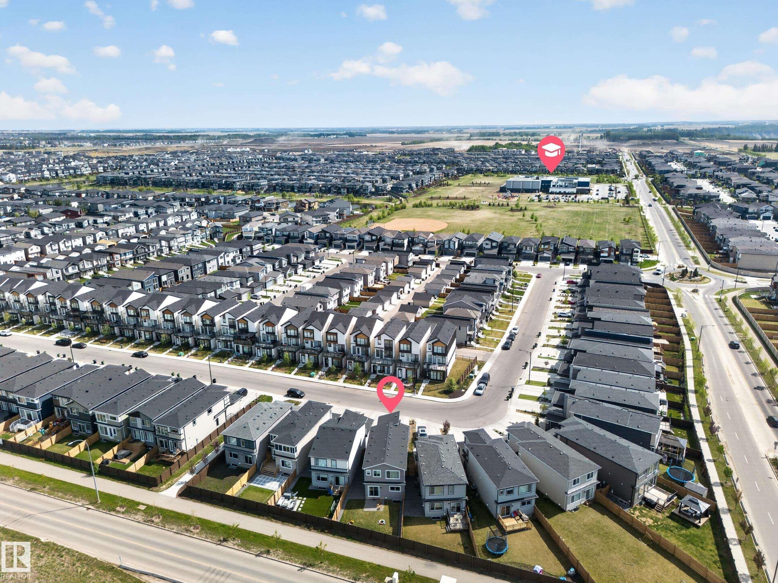 Expansive residential development featuring numerous contemporary homes with dark-pitched roofs - 3337 Kulay Way, Edmonton, AB - Outdoor With View
