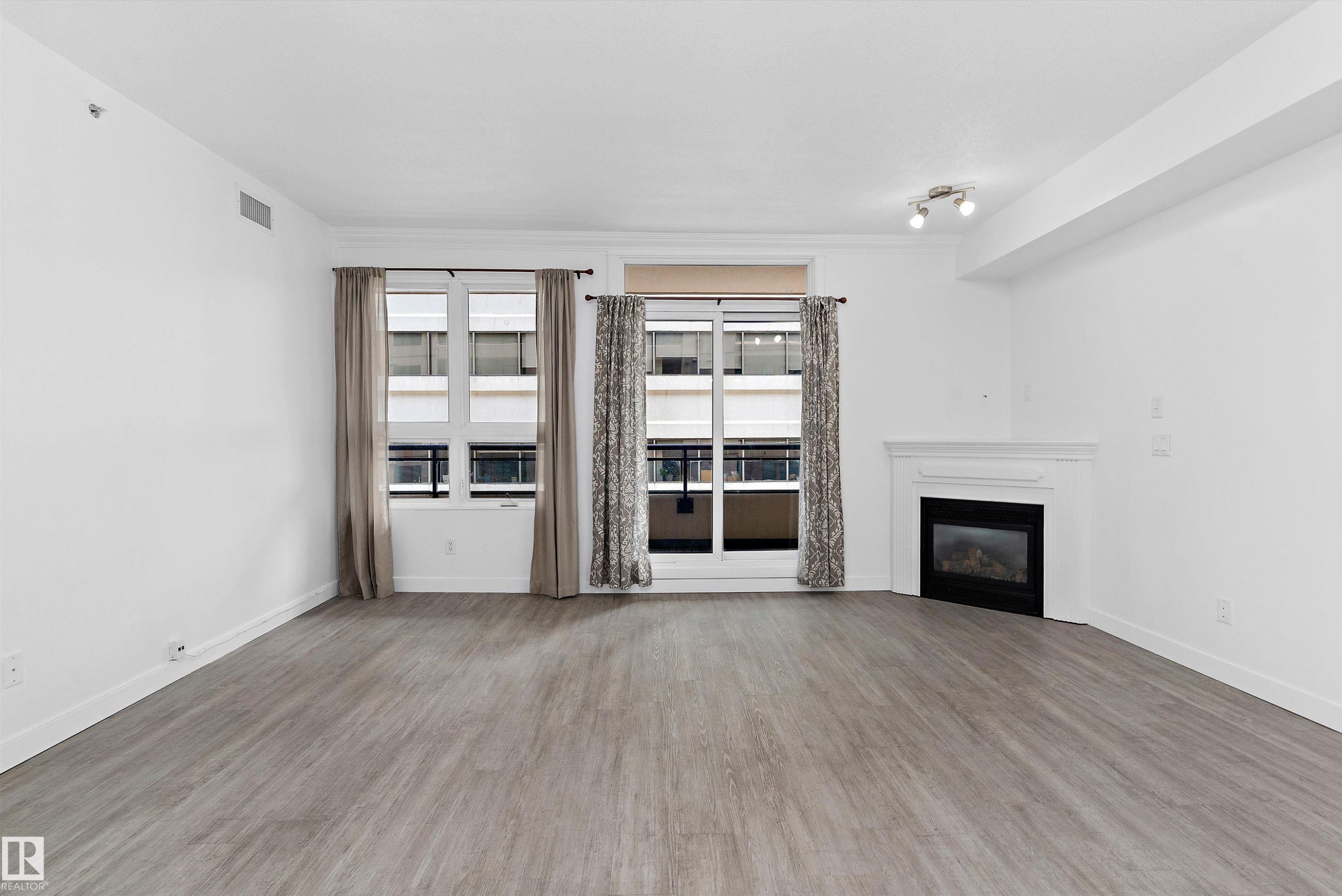 #902 9939 109 St Nw, Edmonton, AB - Indoor Photo Showing Living Room With Fireplace