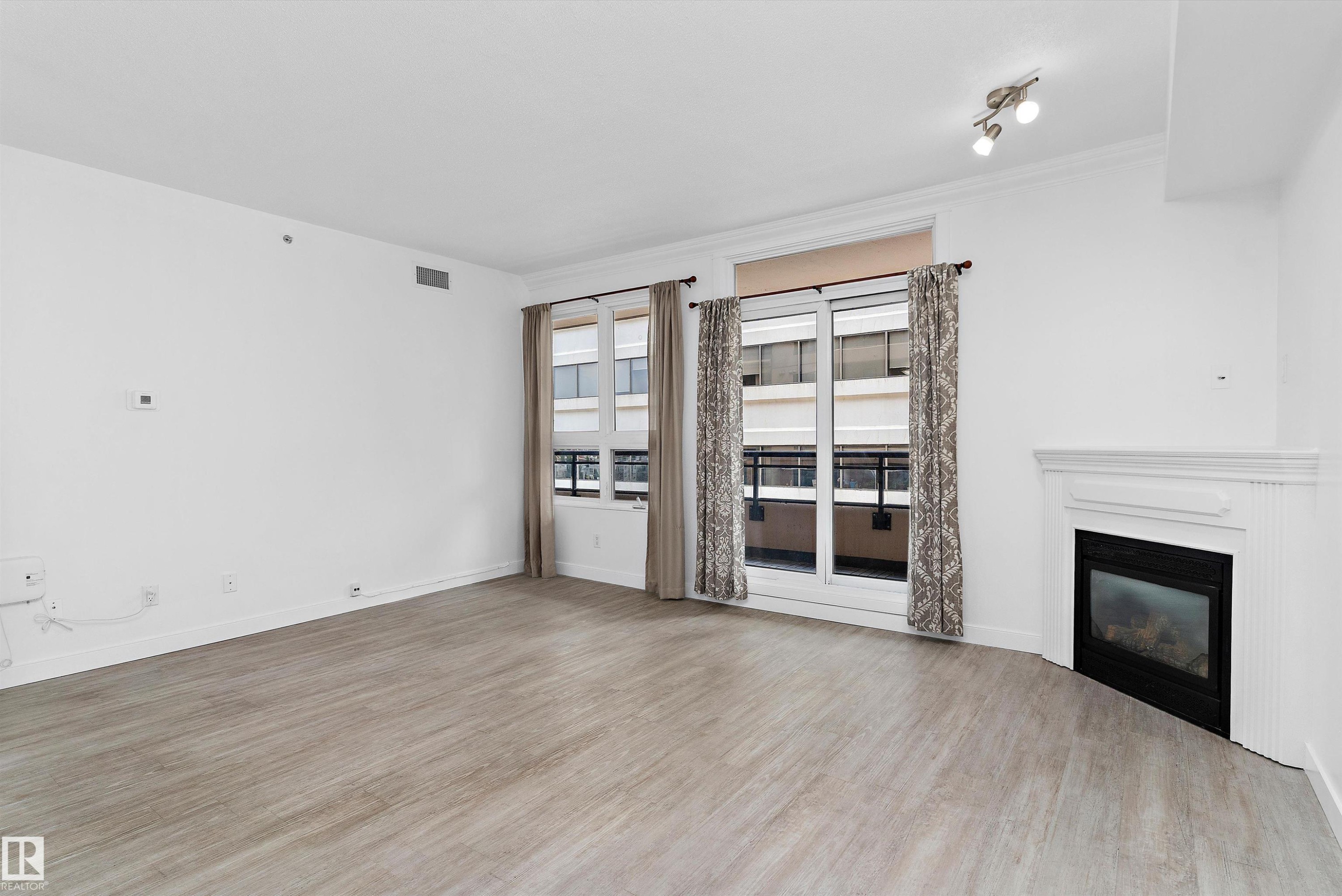 #902 9939 109 St Nw, Edmonton, AB - Indoor Photo Showing Living Room With Fireplace
