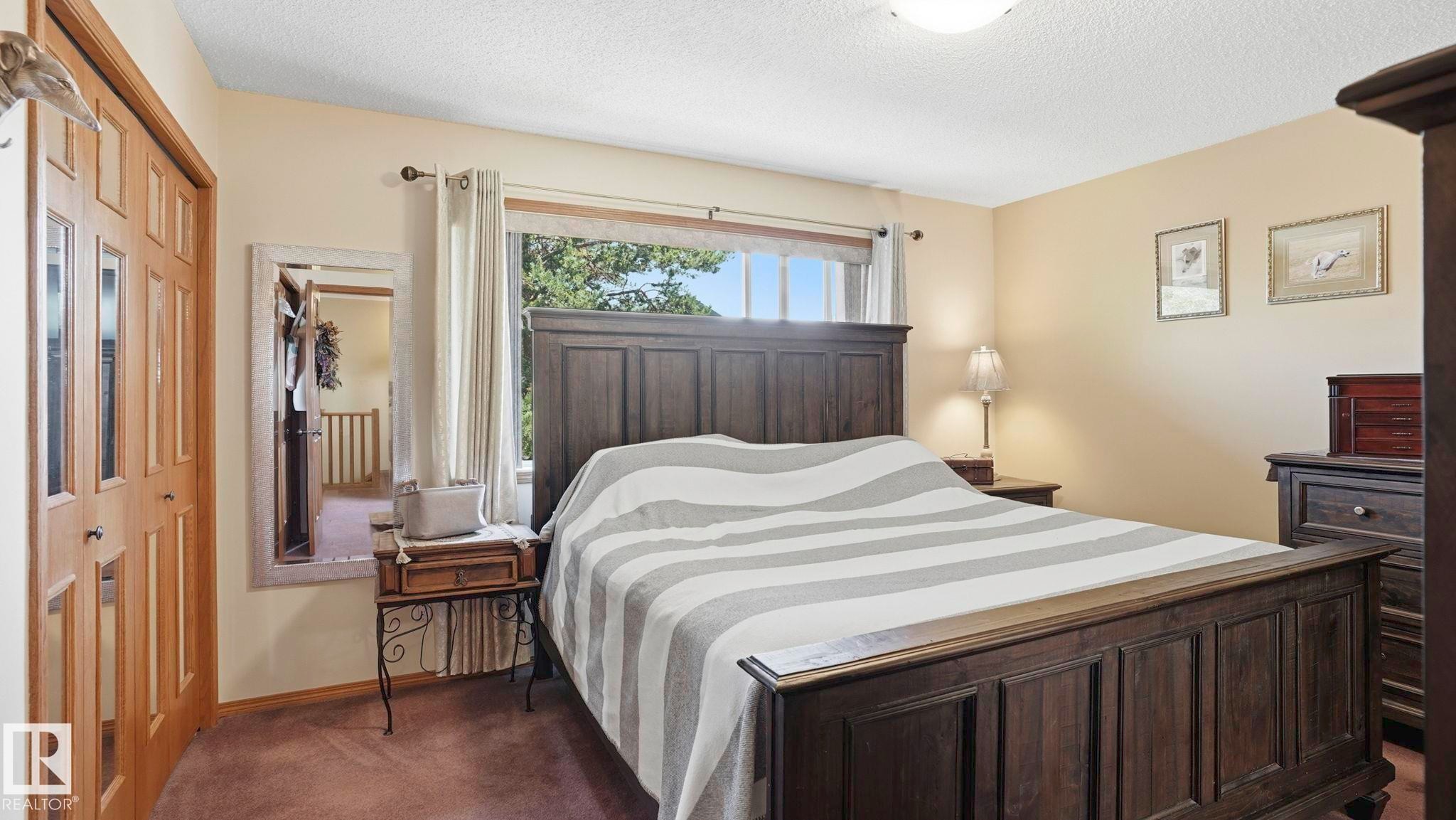 Warm bedroom featuring neutral wall tones and a window with outdoor views - 4309 37A Avenue, Edmonton, AB - Indoor Photo Showing Bedroom