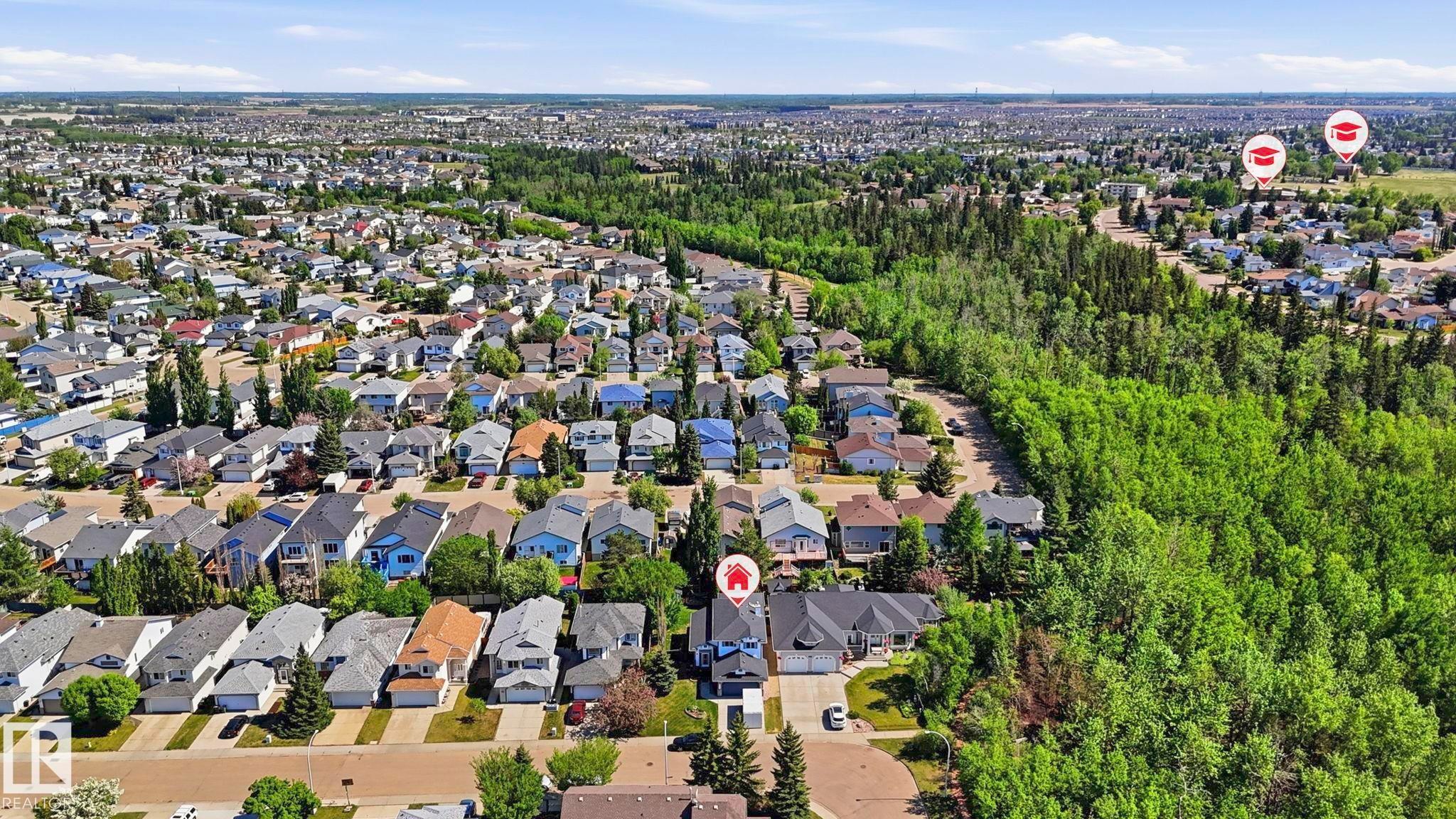 Aerial perspective of a residential neighborhood featuring numerous detached properties, paved streets, and a substantial treed area - 4309 37A Avenue, Edmonton, AB - Outdoor With View
