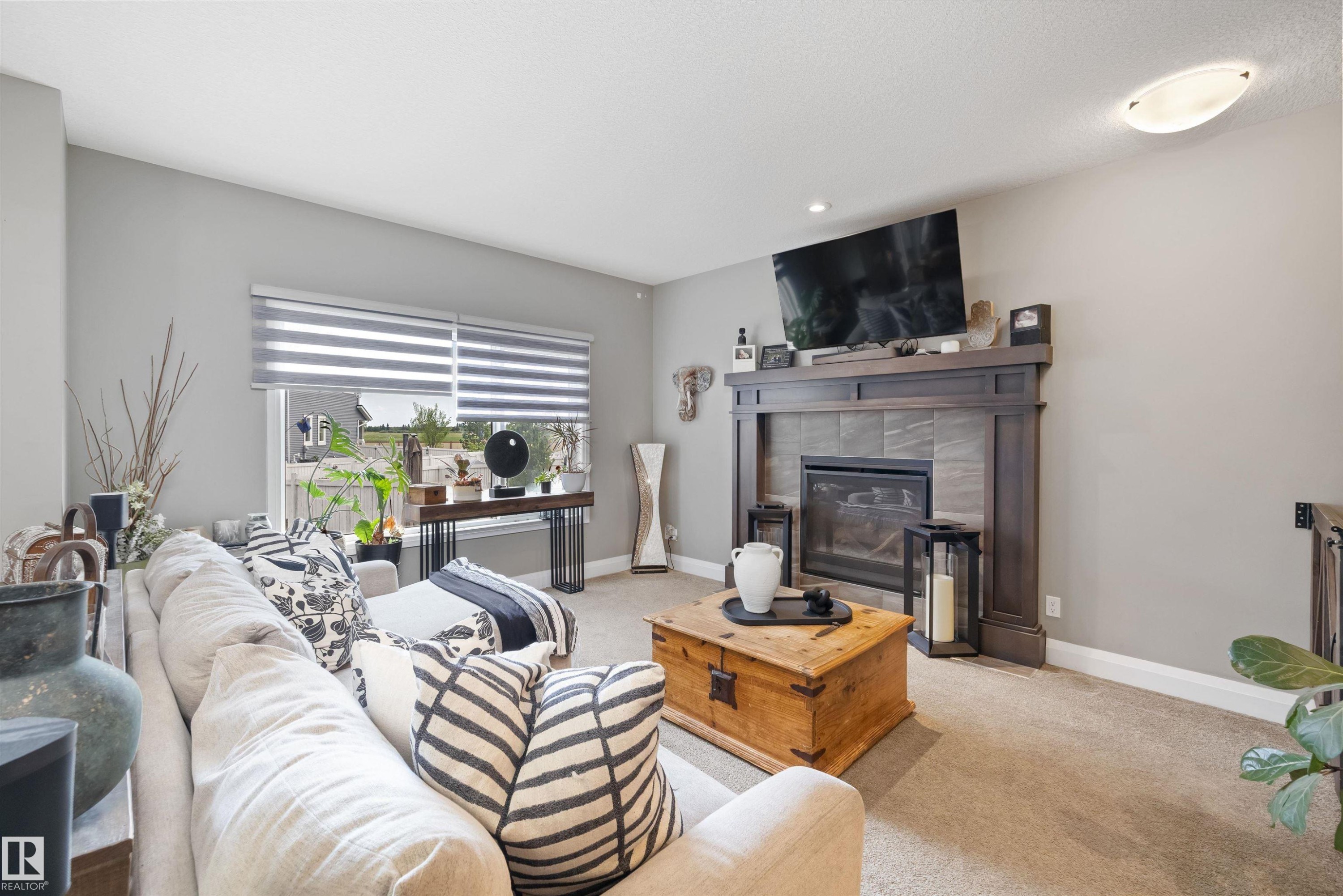 153 Sturtz Bend, Leduc, AB - Indoor Photo Showing Living Room With Fireplace