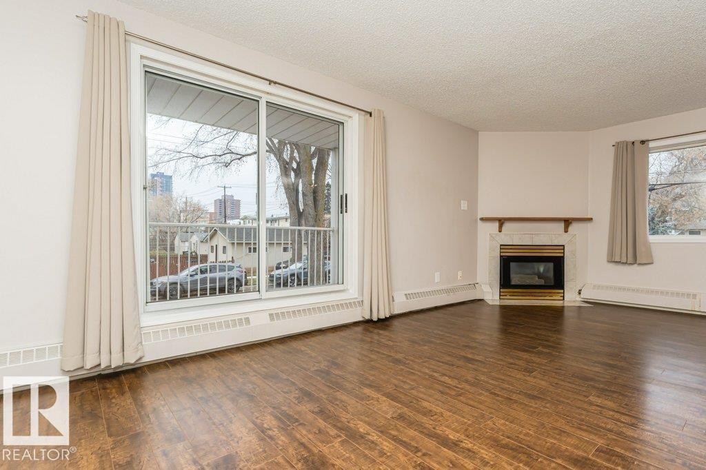 #203 8503 108 St Nw, Edmonton, AB - Indoor Photo Showing Living Room With Fireplace