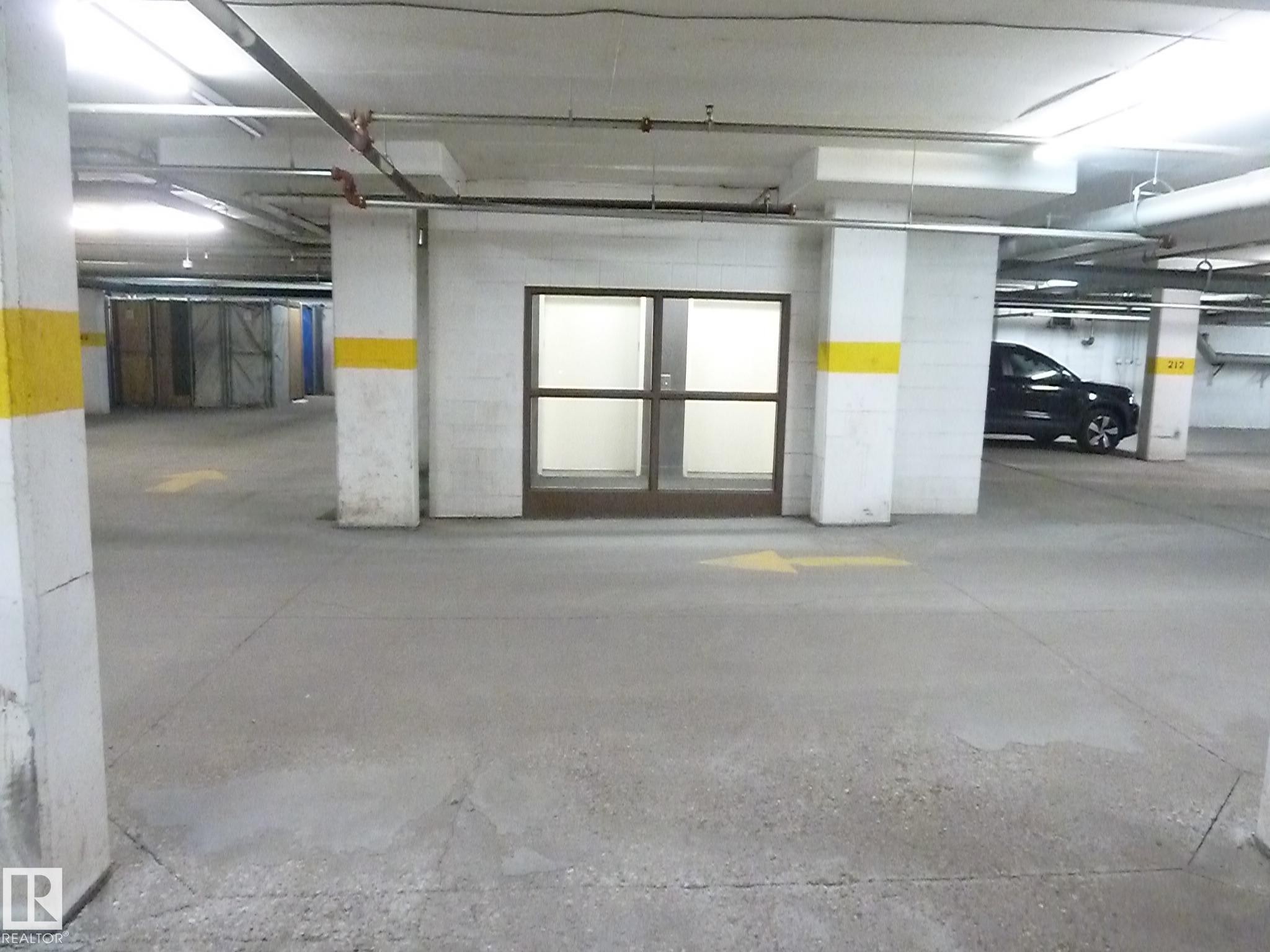 1-104 4245 139 Avenue, Edmonton, AB - Indoor Photo Showing Garage