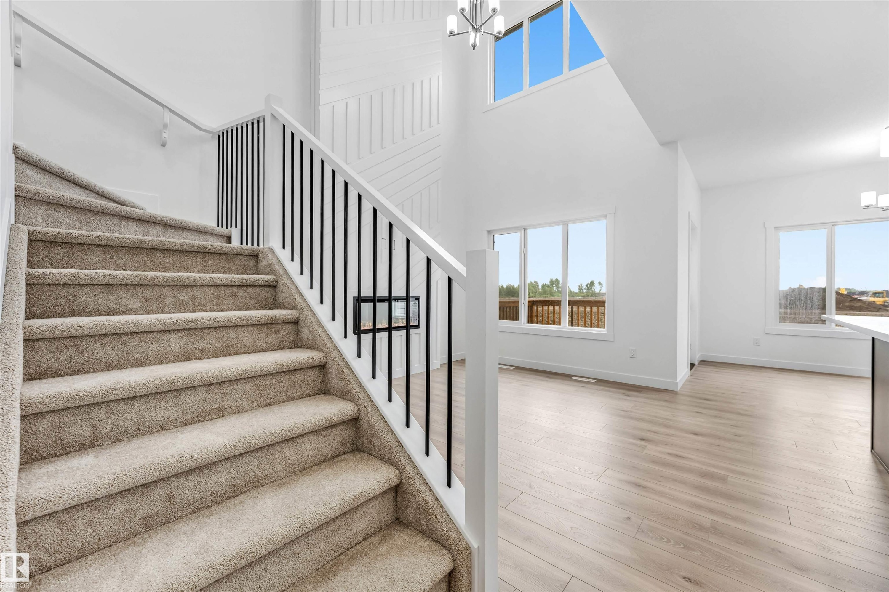 Carpeted staircase with black vertical balusters and white handrails - 1972 210 Street, Edmonton, AB - Indoor Photo Showing Other Room