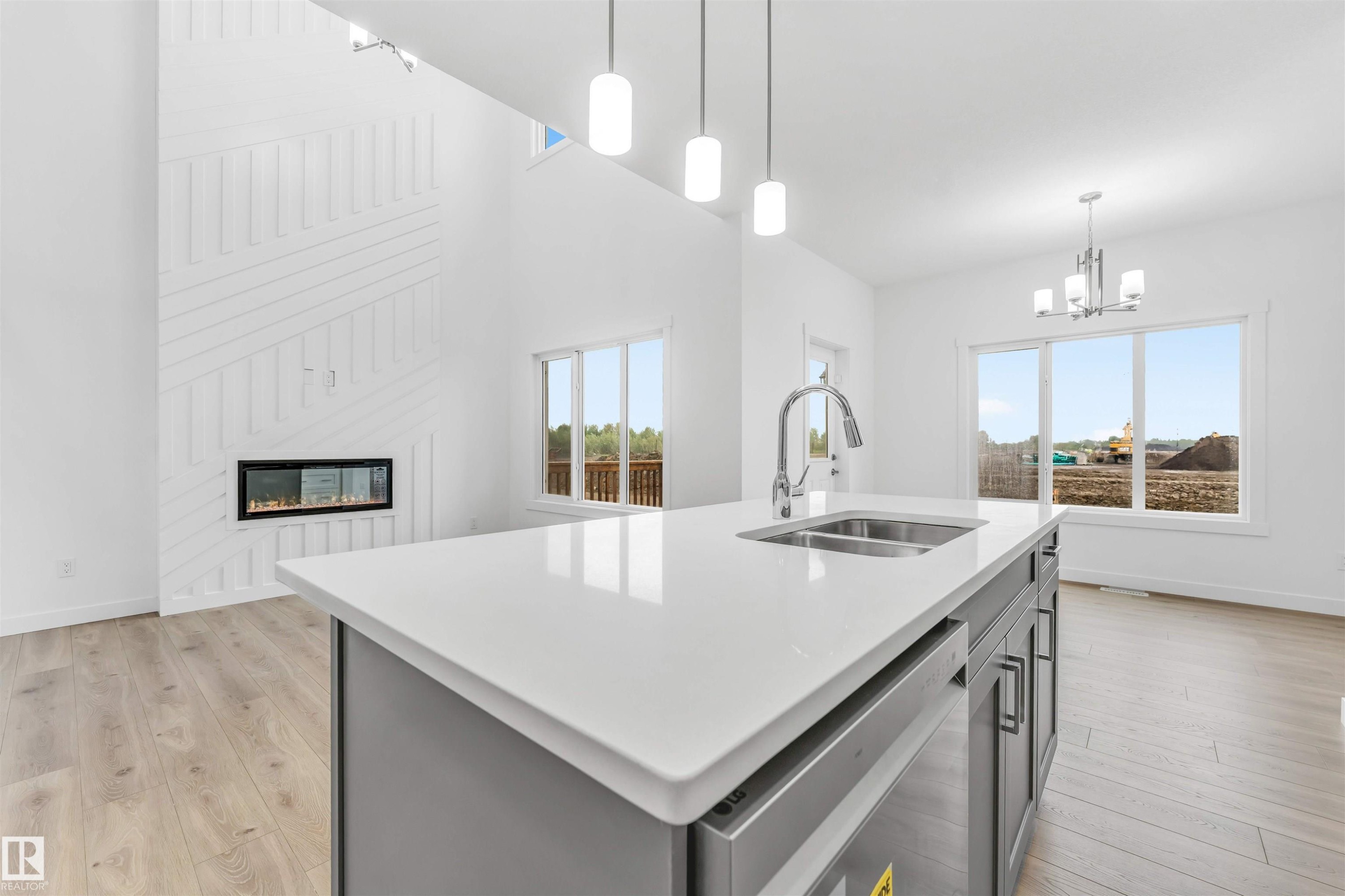 Contemporary kitchen island featuring a dual-basin stainless steel sink, gooseneck faucet, and integrated dishwasher - 1972 210 Street, Edmonton, AB - Indoor Photo Showing Kitchen With Double Sink With Upgraded Kitchen