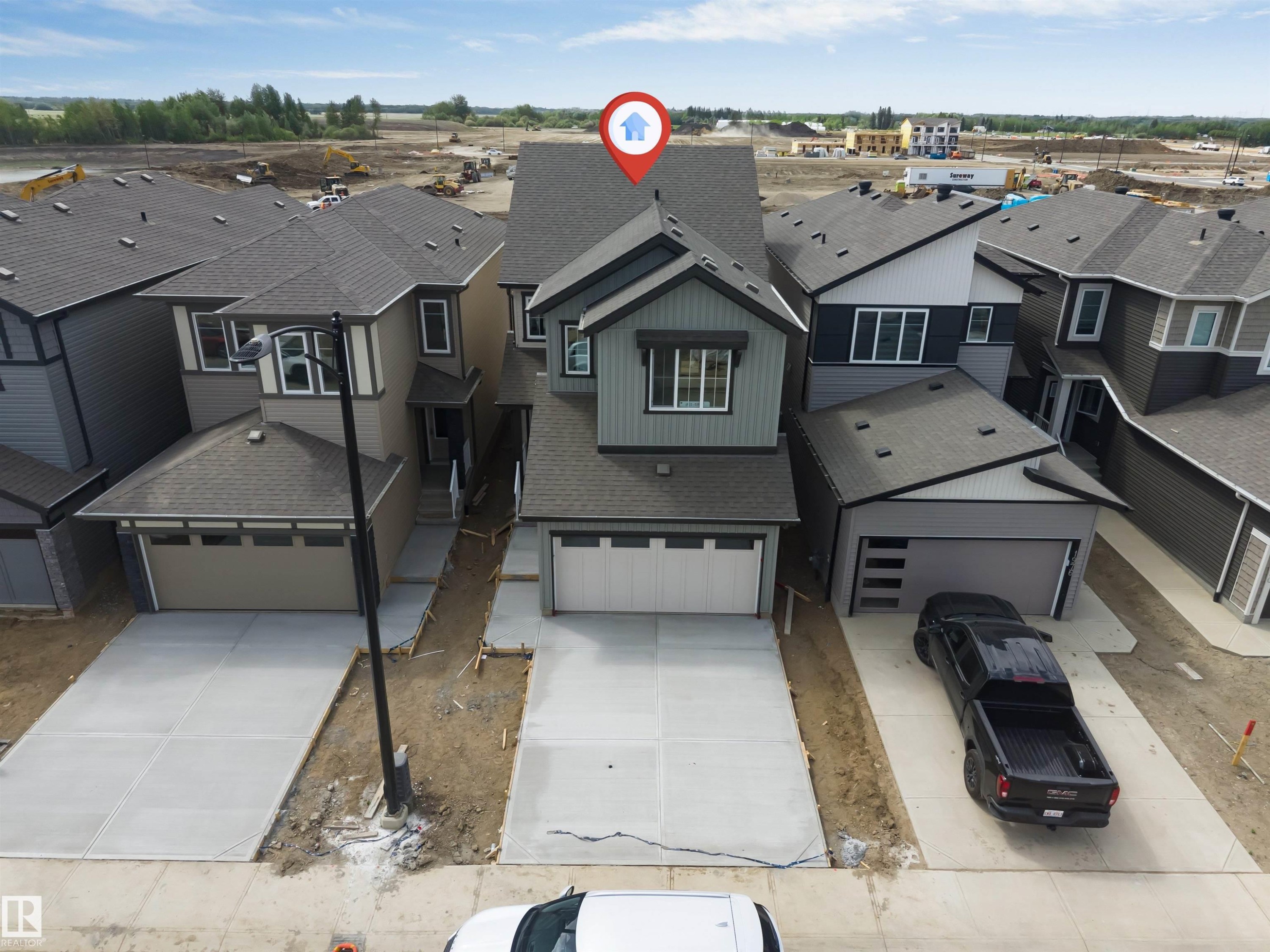 Contemporary two-story home featuring a dual-tone exterior, attached two-car garage, and a concrete driveway - 1972 210 Street, Edmonton, AB - Outdoor With Facade