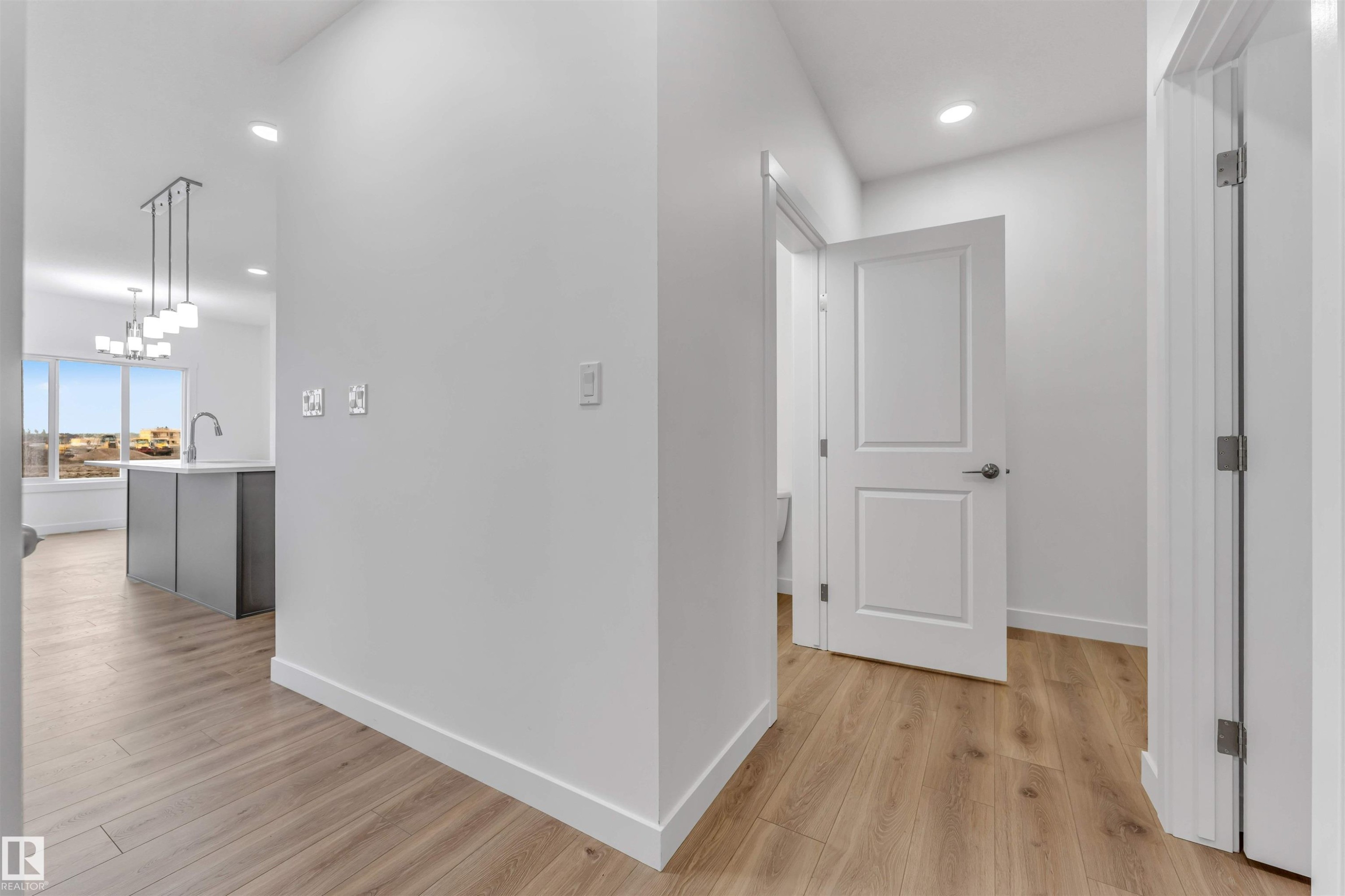 Hallway featuring wood-finish flooring, recessed lighting, white baseboards, and white panel doors - 1972 210 Street, Edmonton, AB - Indoor Photo Showing Other Room