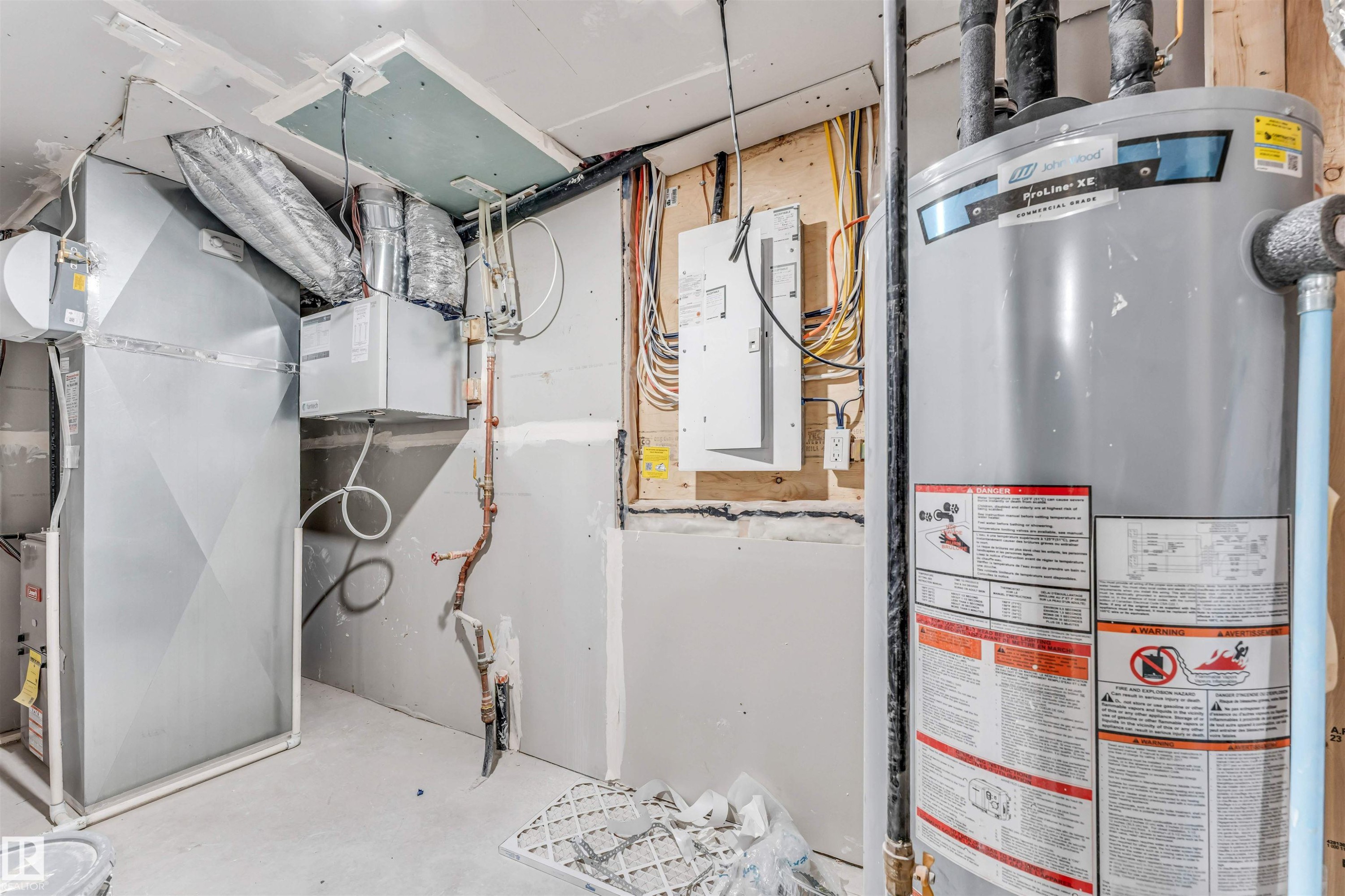 Utility room featuring a water heater, furnace, and exposed electrical wiring - 1972 210 Street, Edmonton, AB - Indoor Photo Showing Basement