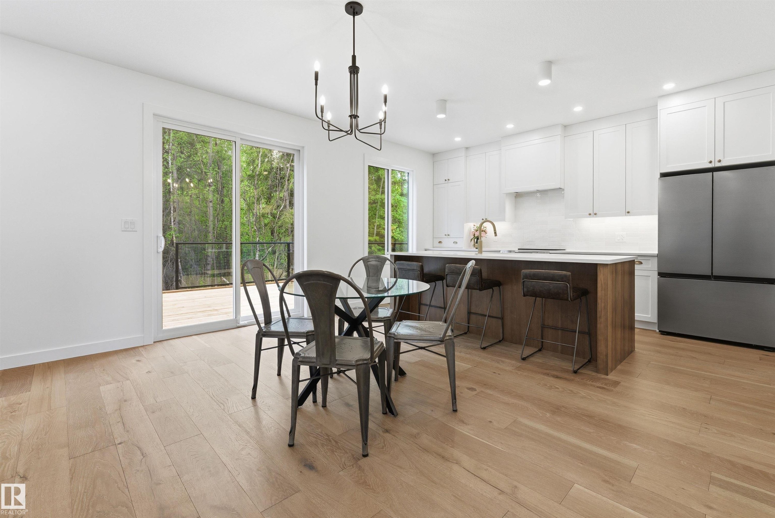 Open-concept kitchen and dining area featuring light wood-finish flooring - 132 Heron Point Close, Rural Wetaskiwin County, AB