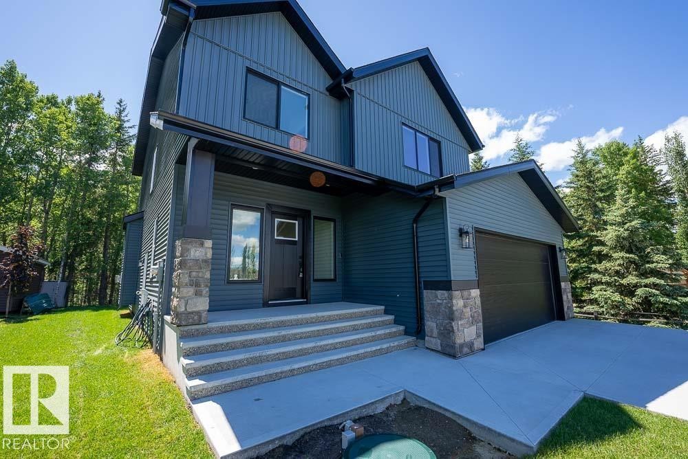 Modern two-story residence featuring a blue vertical and horizontal siding exterior - 132 Heron Point Close, Rural Wetaskiwin County, AB