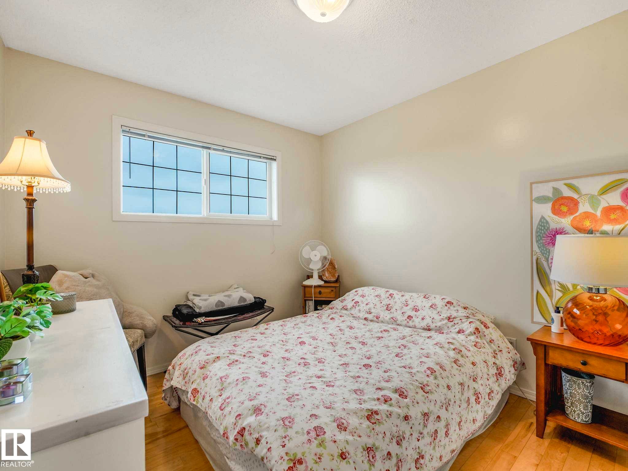 Bedroom featuring light-toned walls and wood-finish flooring - 4031 38 Street, Edmonton, AB
