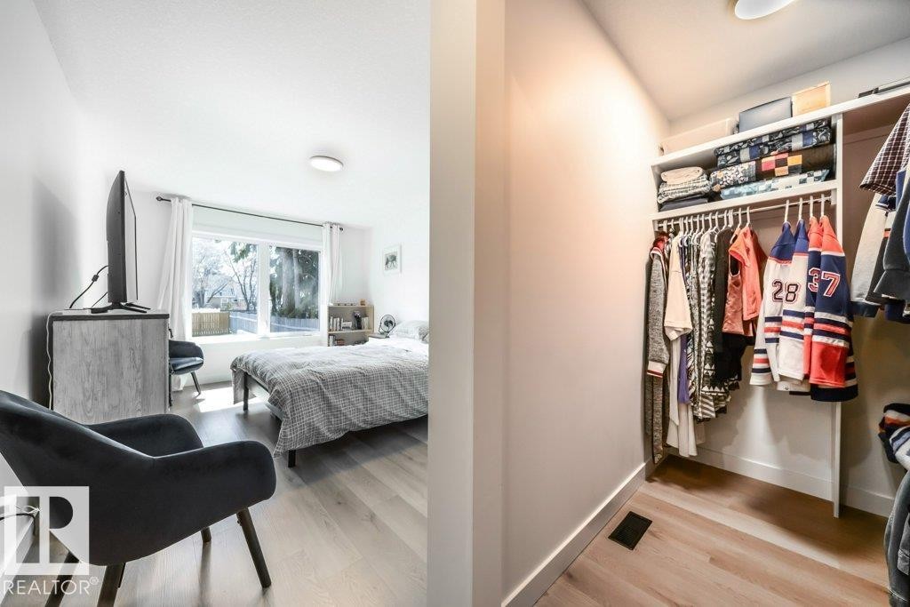 Bright room featuring wood-finish flooring and a large window - 11303 111 Avenue, Edmonton, AB - Indoor