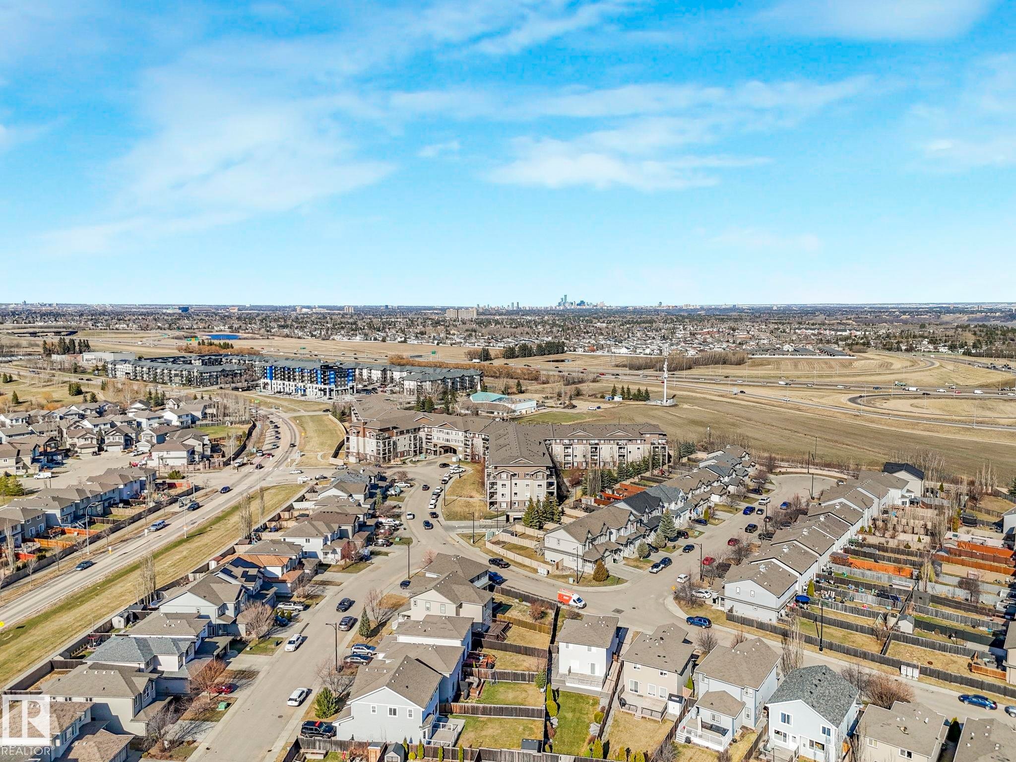 Aerial perspective showcasing a residential area with varied housing styles - 322 1520 Hammond Gate Nw, Edmonton, AB - Outdoor With View