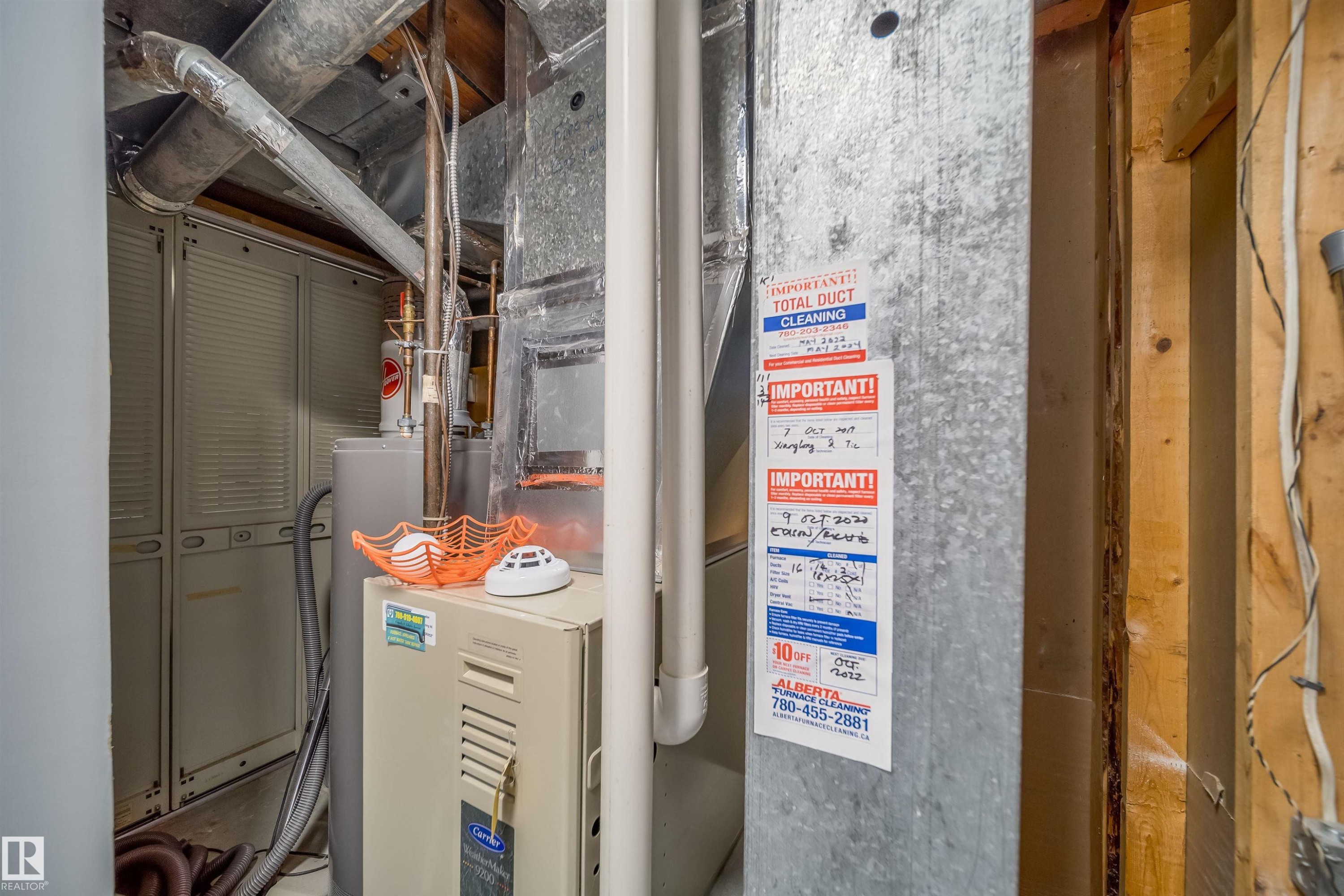 Utility area featuring ductwork, a water heater, and a furnace unit - 8512 142A Avenue, Edmonton, AB