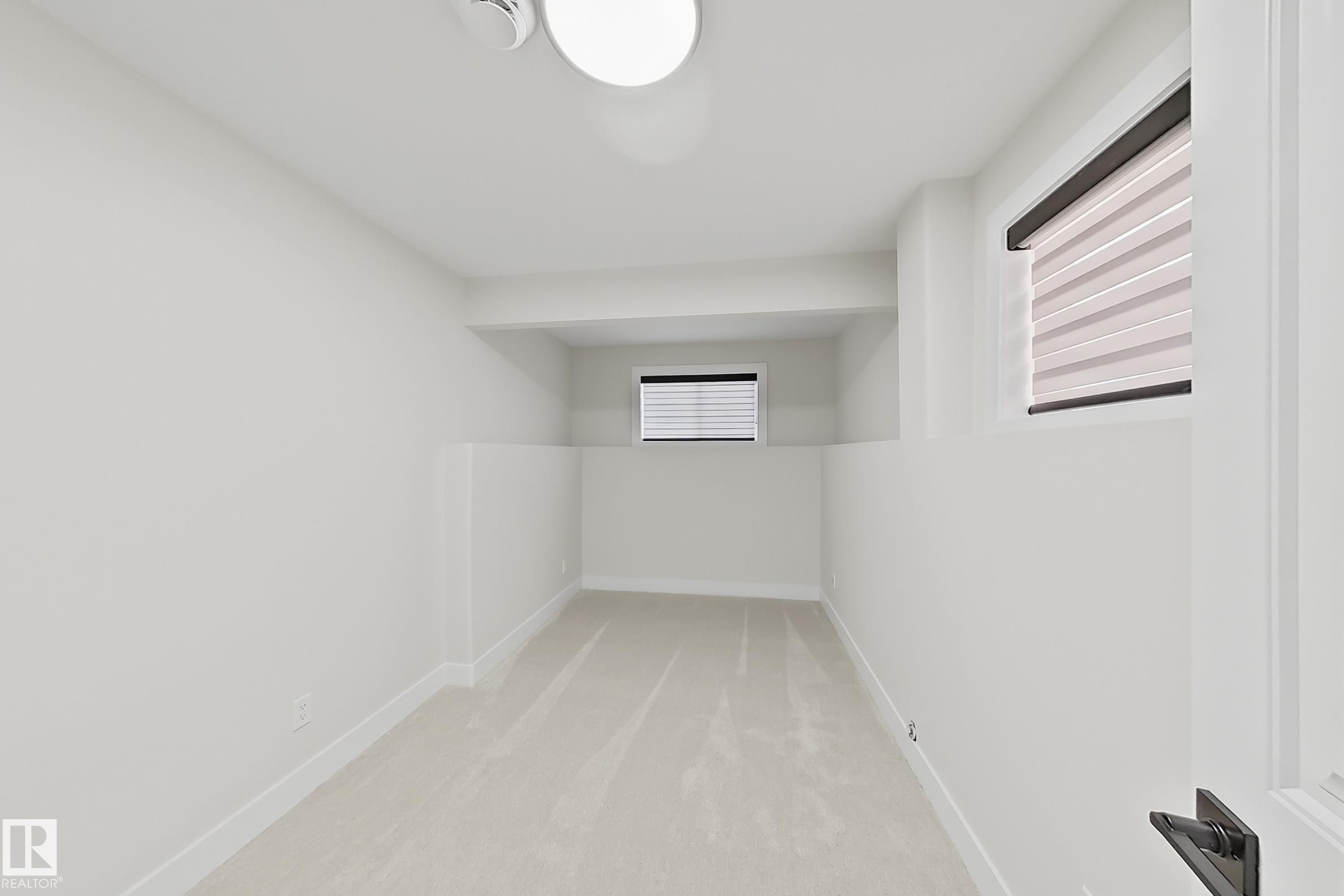 Bright interior space featuring light-colored carpeting, white wall paint, and white trim - 6144 166 Avenue, Edmonton, AB