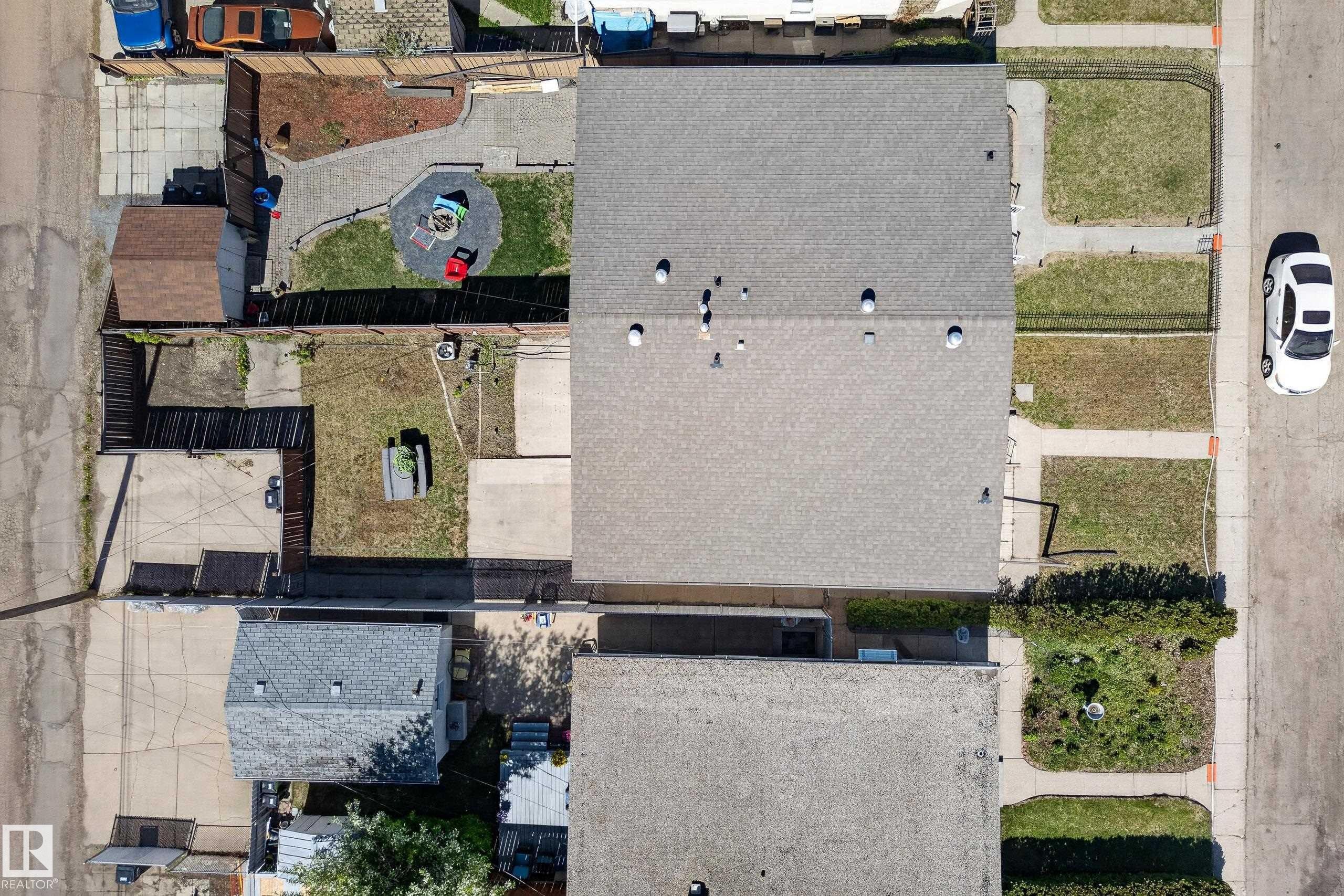 Aerial view showcasing a residential property with a shingle roof and a spacious backyard - 6203 90 Avenue, Edmonton, AB