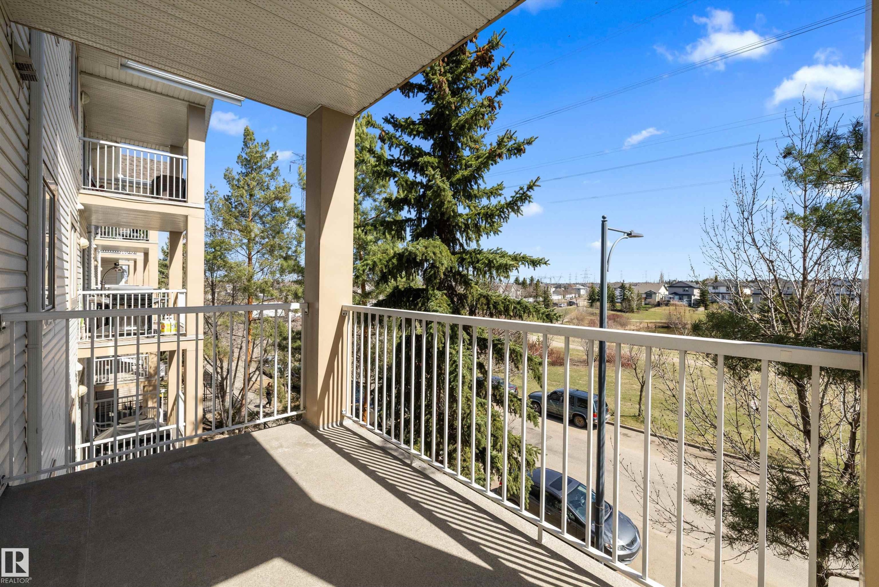 Private balcony featuring a concrete floor and white metal railing - 320 245 Edwards Drive, Edmonton, AB
