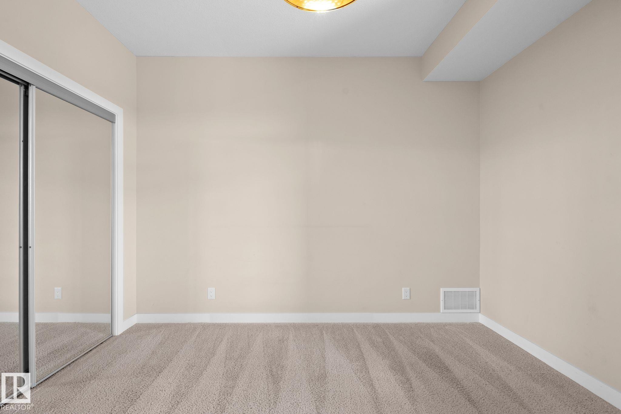 Neutral-toned walls complement plush carpeting - 309 625 Leger Way, Edmonton, AB