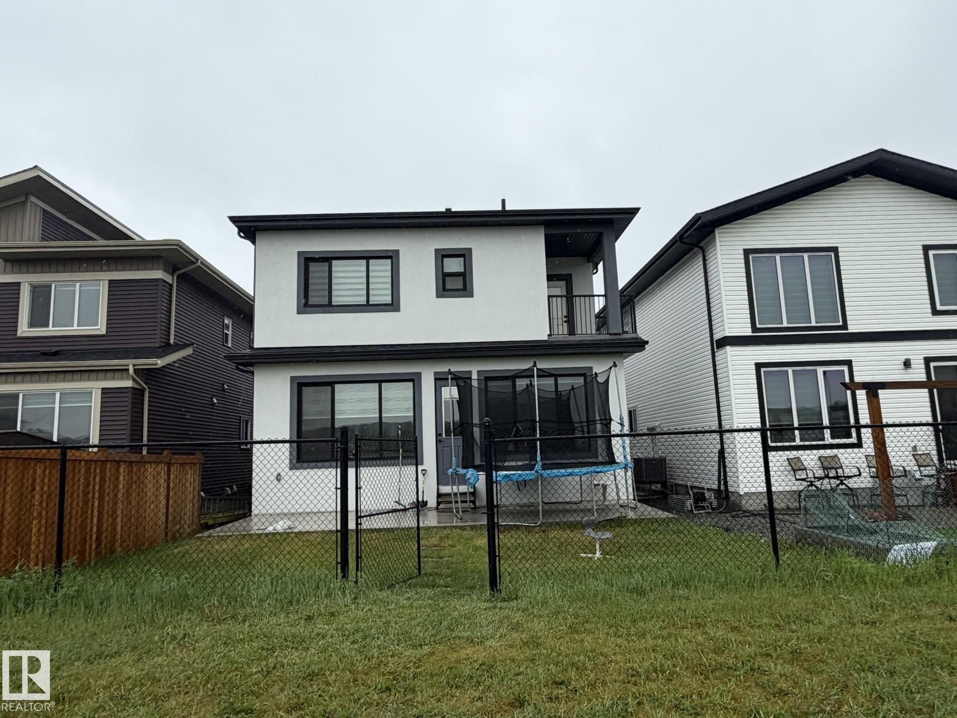 Two-story property with white stucco siding and contrasting black trim details - 2123 18 Avenue, Edmonton, AB