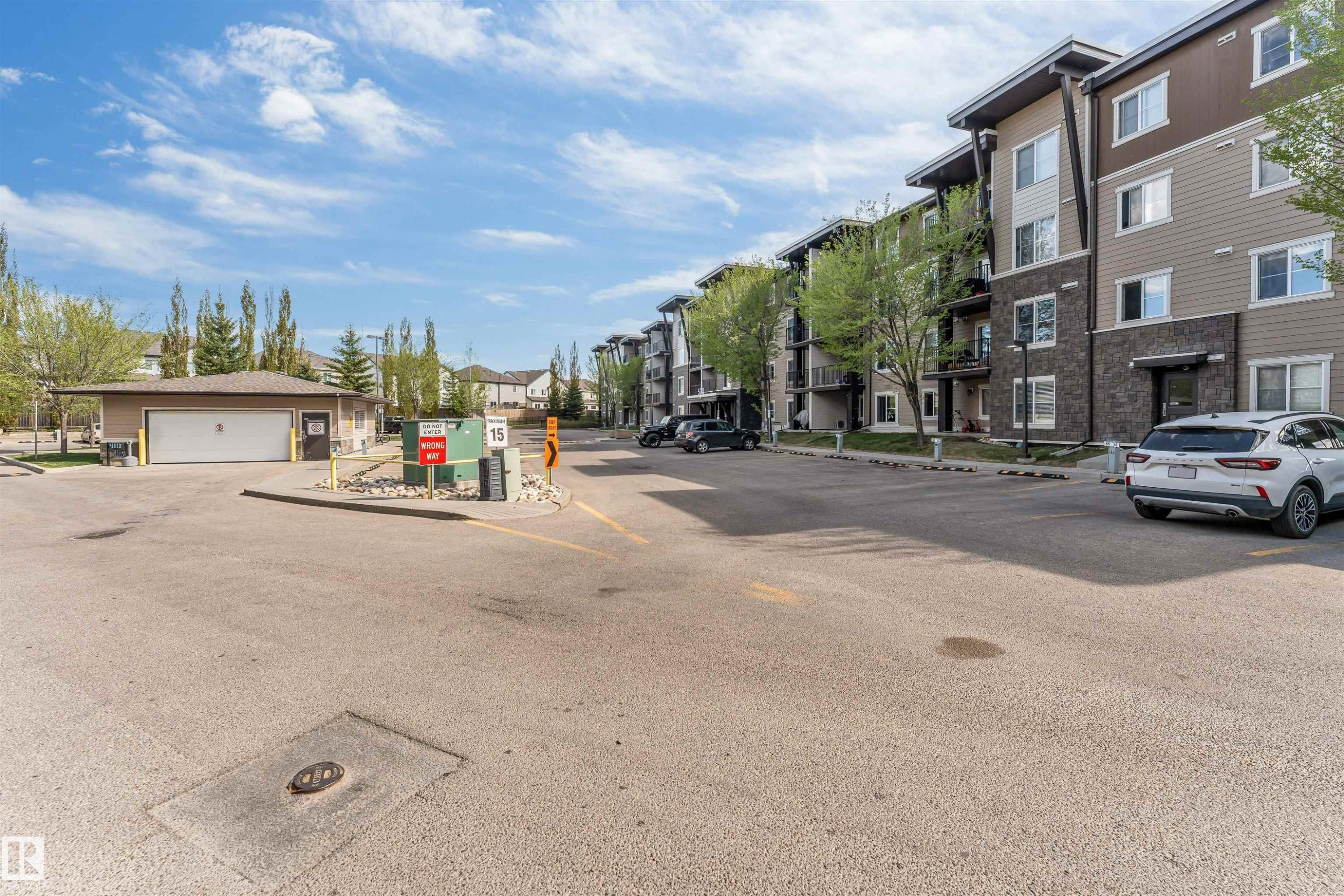 Multi-story residential building with contemporary siding and stone accents - 320 534 Watt Boulevard, Edmonton, AB - Outdoor