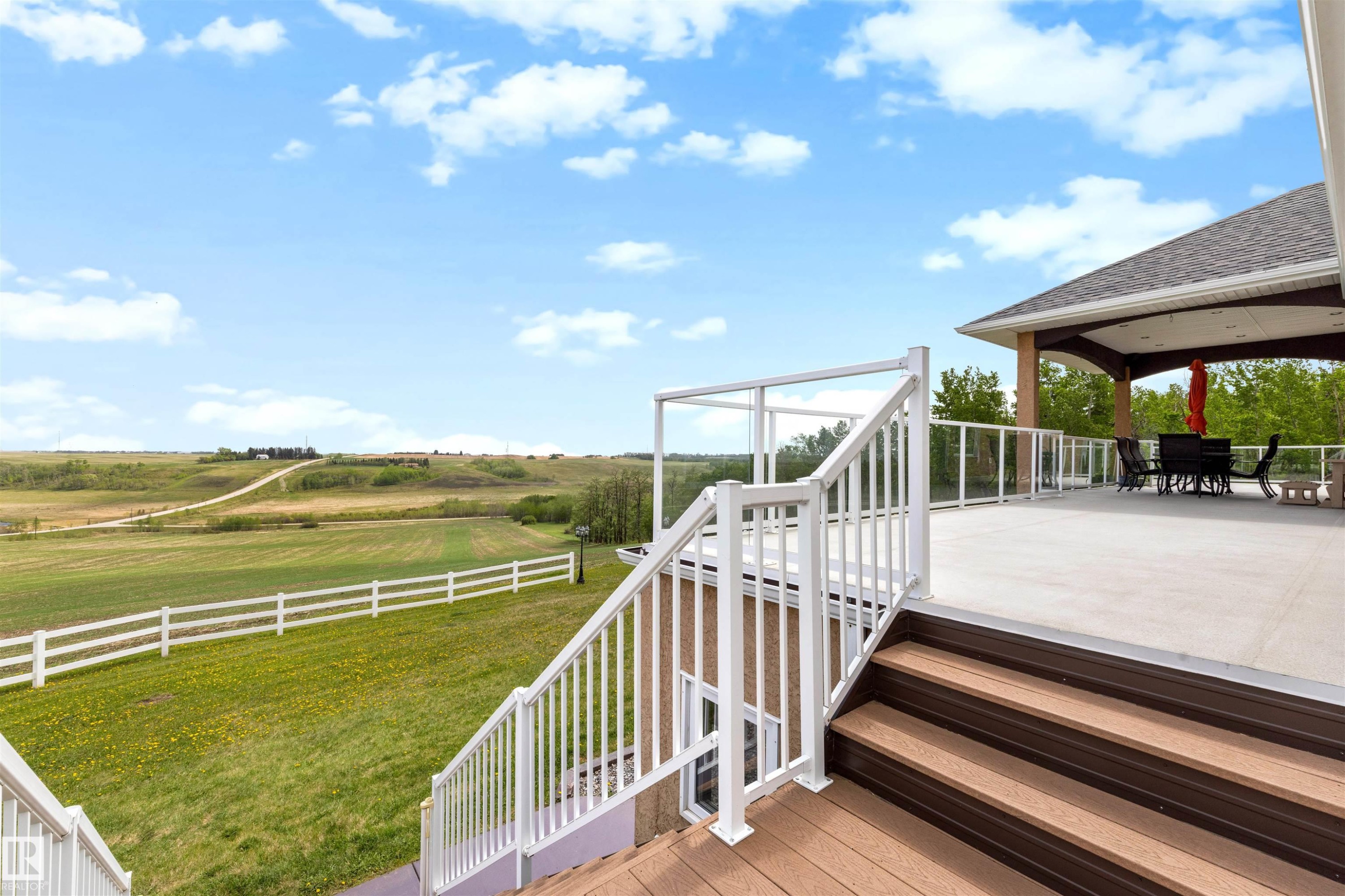 Spacious outdoor deck featuring light-colored surfacing and a covered patio area - 28125 Highway 587, Rural Red Deer County, AB - Outdoor With Deck Patio Veranda