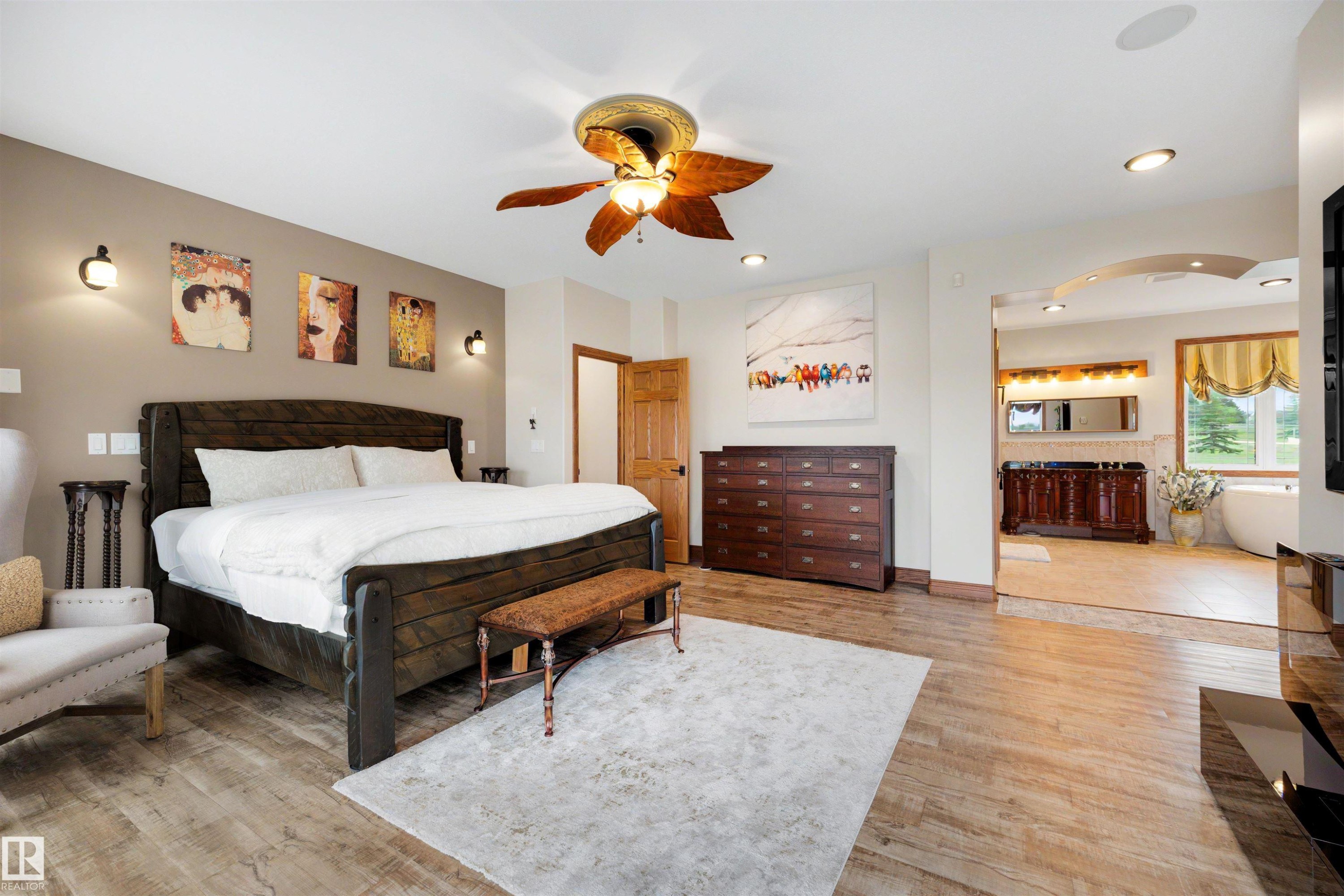 Spacious bedroom featuring wood-finish flooring, a ceiling fan with integrated lighting, and recessed ceiling lights - 28125 Highway 587, Rural Red Deer County, AB - Indoor Photo Showing Bedroom