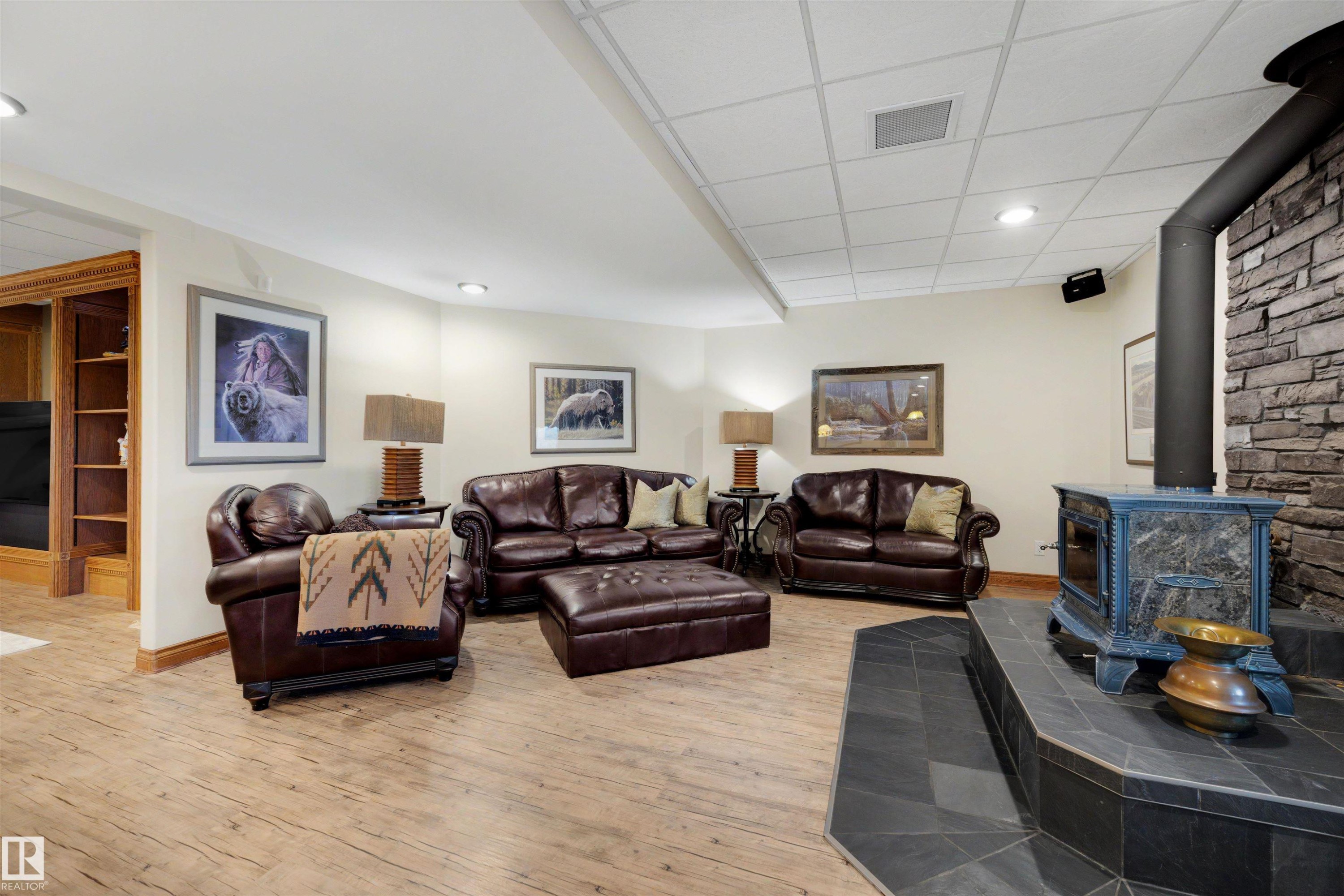Recessed lighting illuminating a spacious room with wood-finish flooring - 28125 Highway 587, Rural Red Deer County, AB - Indoor