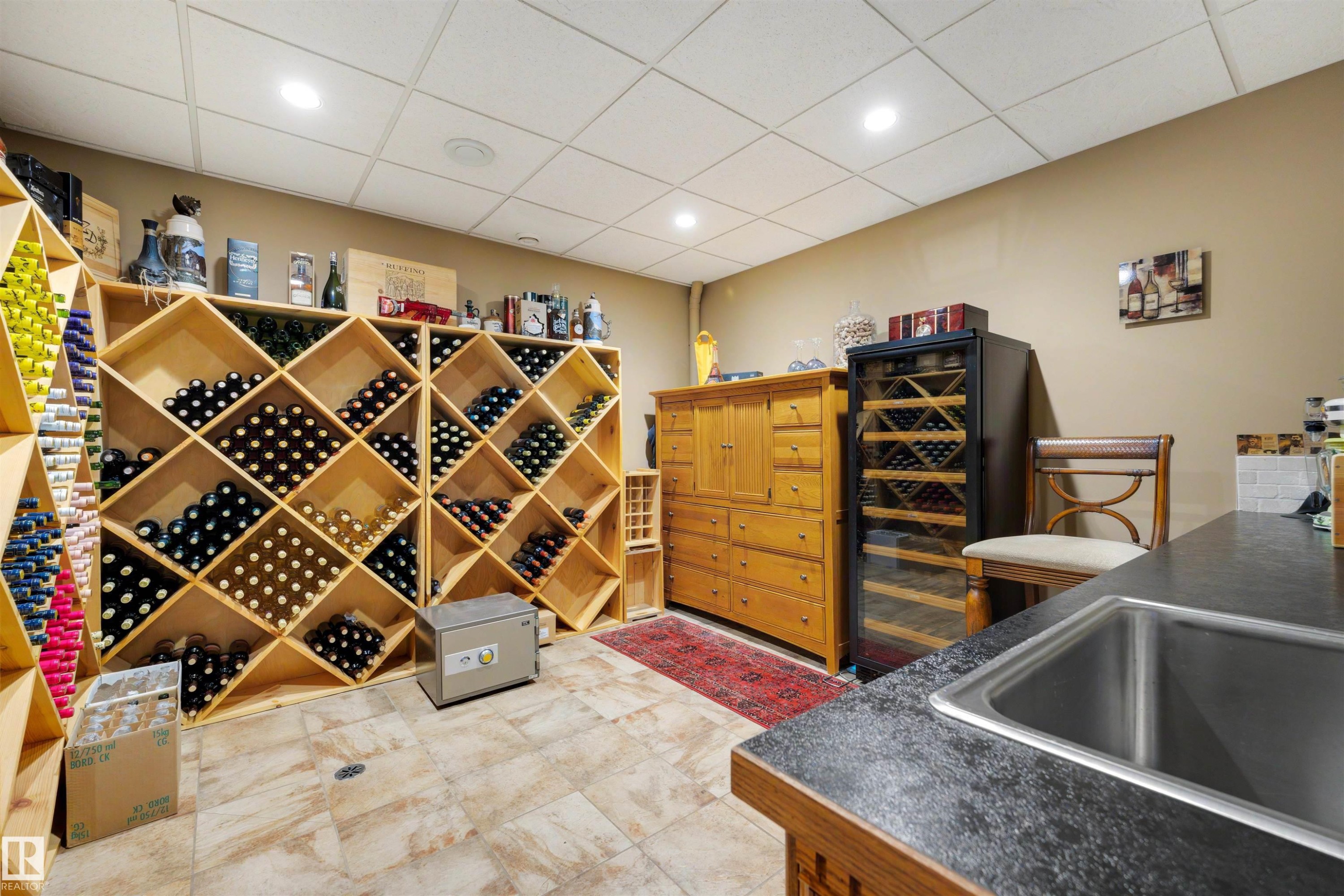 Dedicated wine cellar featuring extensive light wood bottle storage, tile flooring, and recessed lighting - 28125 Highway 587, Rural Red Deer County, AB - Indoor