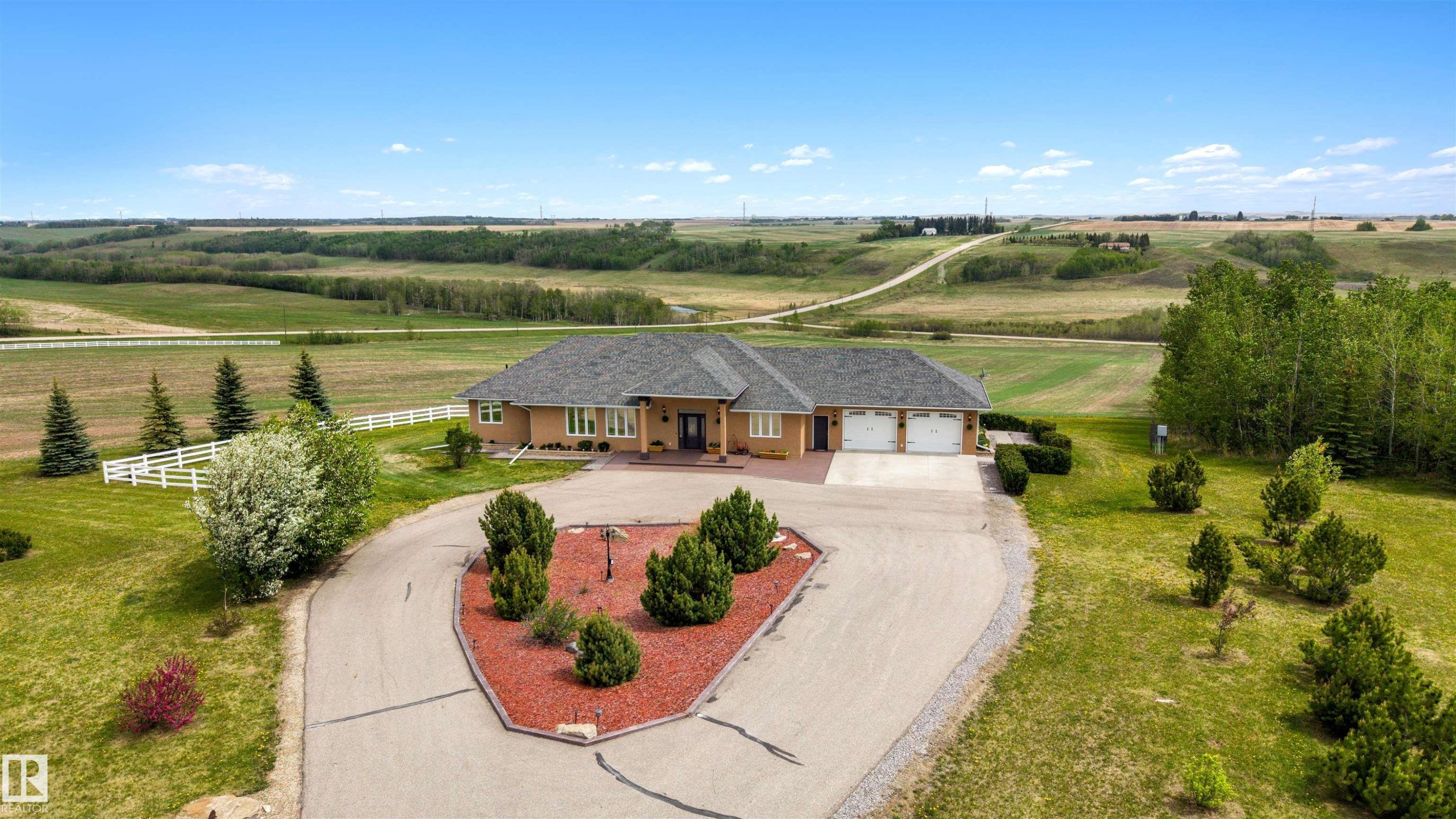 Expansive property featuring a single-story residence, attached three-car garage, and a paved circular driveway - 28125 Highway 587, Rural Red Deer County, AB - Outdoor With View