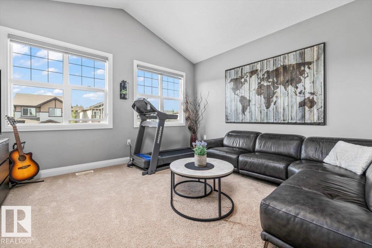 Upper floor | Bright interior room featuring a vaulted ceiling and ample natural light from multiple large windows - 54 Spring Gate, Spruce Grove, AB