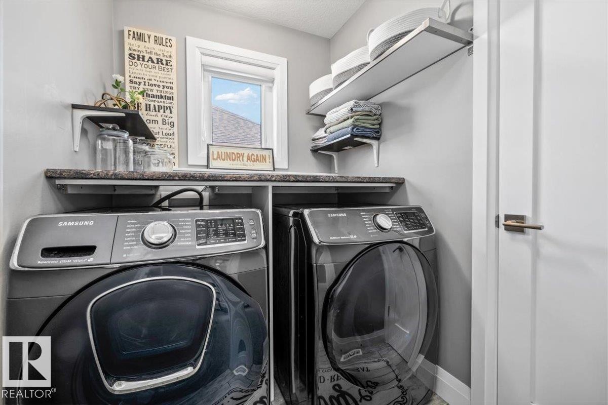 Dedicated laundry space featuring a side-by-side washer and dryer set - 54 Spring Gate, Spruce Grove, AB
