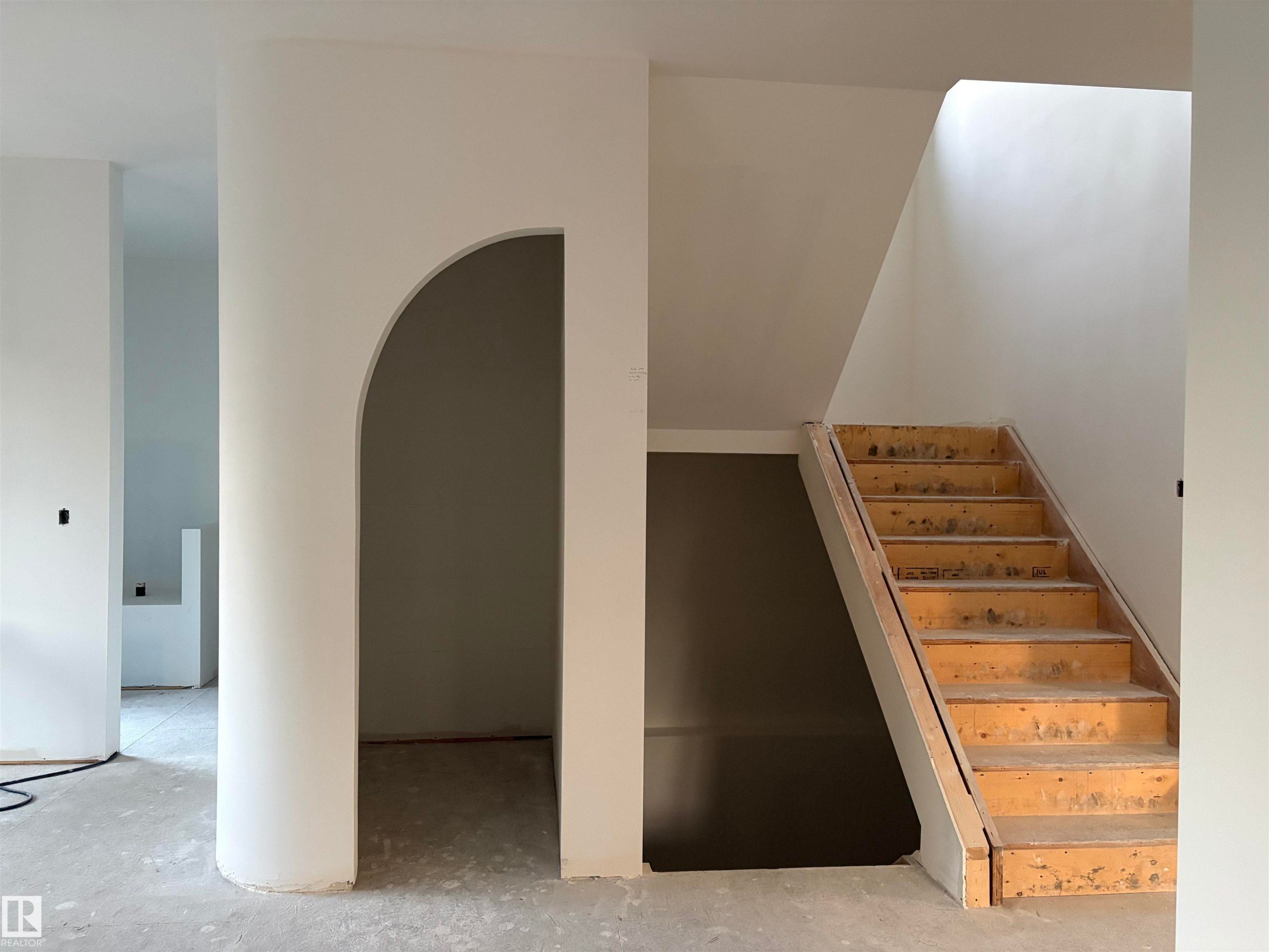 Arched entryway opening to a bright interior with a skylight - 9243 148 Street, Edmonton, AB