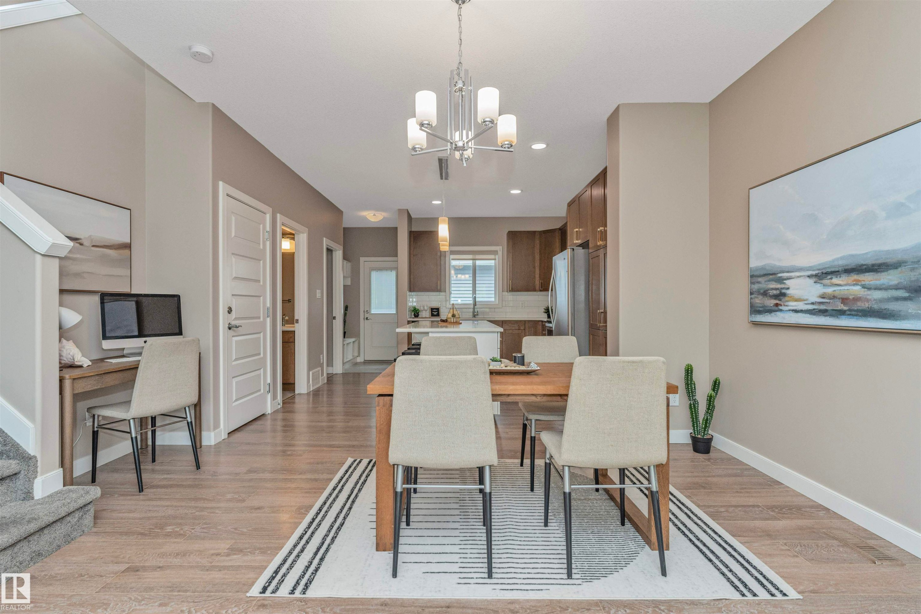 Open-concept dining area featuring wood-finish flooring, a modern chandelier, and recessed lighting - 22124 85 Avenue Nw, Edmonton, AB - Indoor Photo Showing Dining Room