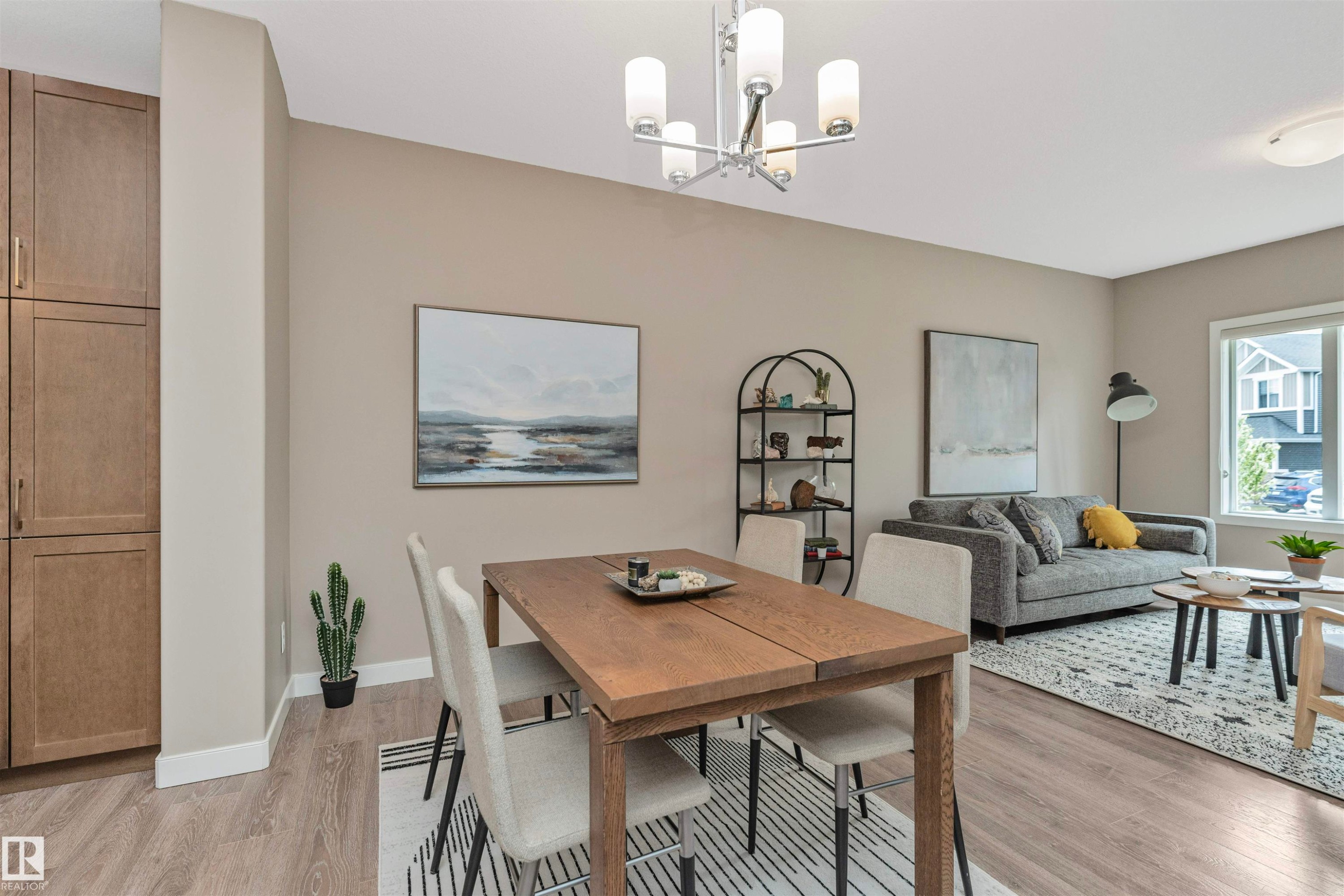 Open-concept living space featuring wood-finish flooring, recessed lighting, and a modern chandelier - 22124 85 Avenue Nw, Edmonton, AB - Indoor