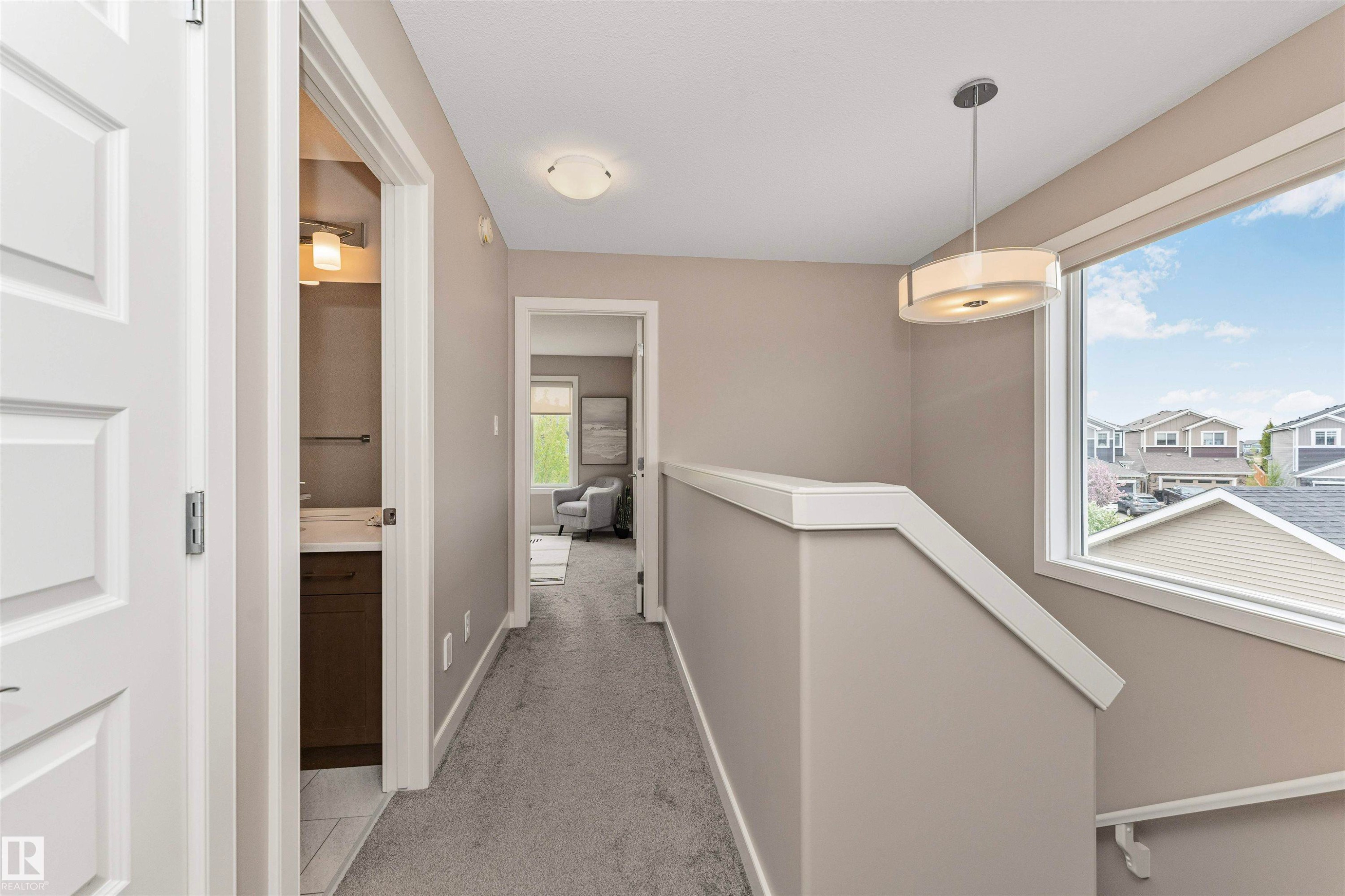 Upper-level hallway featuring neutral wall paint, gray carpeting, and white trim - 22124 85 Avenue Nw, Edmonton, AB - Indoor Photo Showing Other Room